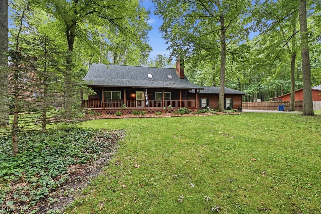 Nestled on a picturesque wooded acre, this exceptional handcrafted log home offers the perfect blend of rustic charm, privacy, and modern comfort. Boasting 2,067 square feet, 3 bedrooms, and 2 full baths, this one-of-a-kind retreat welcomes you with timeless character and warm architectural details throughout.

The inviting great room is the heart of the home, featuring soaring beamed ceilings, custom built-in bookcases, and a cozy wood-burning stove that creates the perfect setting for relaxing or entertaining. The open-concept kitchen offers a breakfast bar, generous dining area, and seamless flow into the main living spaces.

Two spacious bedrooms and a full bath are conveniently located on the first floor, while the private second-floor primary suite provides a peaceful retreat. An open loft overlooks the living room and is already equipped with a wet bar connection, offering endless possibilities for a lounge, home office, or entertainment space.

Outdoor living is just as impressive with a screened-in porch, expansive patio, and tranquil wooded surroundings that invite year-round enjoyment. Practical features include a 3-car garage, a dedicated parking pad ideal for an RV, boat, or construction equipment, and an additional storage shed.

The full basement includes a partially finished room, providing flexible space for a recreation room, fitness area, workshop, or additional storage.

Offering the rare combination of authentic log home craftsmanship, functional amenities, and serene natural surroundings, this distinctive Columbia Station property is an exceptional opportunity to enjoy peaceful country living with everyday convenience.

Schedule your private showing today and experience the warmth, character, and unmatched lifestyle this remarkable log home has to offer before it's gone.