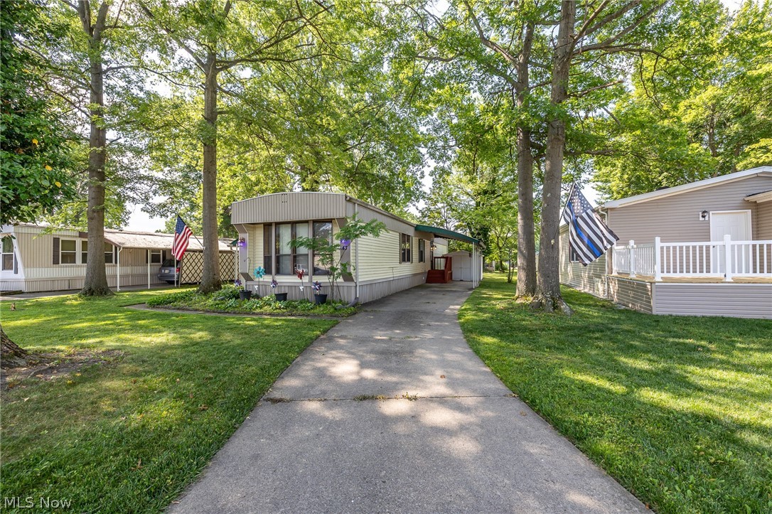 COLUMBIA Park IS A 55 AND OLDER CONCEPT OF LIVING and is Ohio’s Premier Adult Land Lease Community! Amenities Include: Gated entrance! On site Shopping Plaza! On site Management! Walking Path/Dog Walking Path! Shuffleboard! Bocce Ball! Library! Crafts, and Social Hall!  WELCOME HOME to this 1982 Rochester Singlewide Manufactured Home offering 980 sqft. (70 x 14) featuring 2 Bedrooms, 1 Full Bath and 1 Half Bath, Formal Living and Dining Room, Kitchen, Laundry Area and an Awesome 3 Season Sunroom, step down, measuring 30 x 12 which gives you an additional 360 sqft.  Please do not judge this home by it's age there are numerous upgrades which are as follows:  Since 2019 the following have been replaced.  Roof, HVAC System, Hot Water Tank, Stove, Refrigerator, Washer and Dryer, Front Bedroom Ceiling Fan, Living Room Ceiling Fan, and Grab Bars.  This home is nicely landscaped, on a larger lot with beautiful green space.  Why not set up your own personal viewing today.