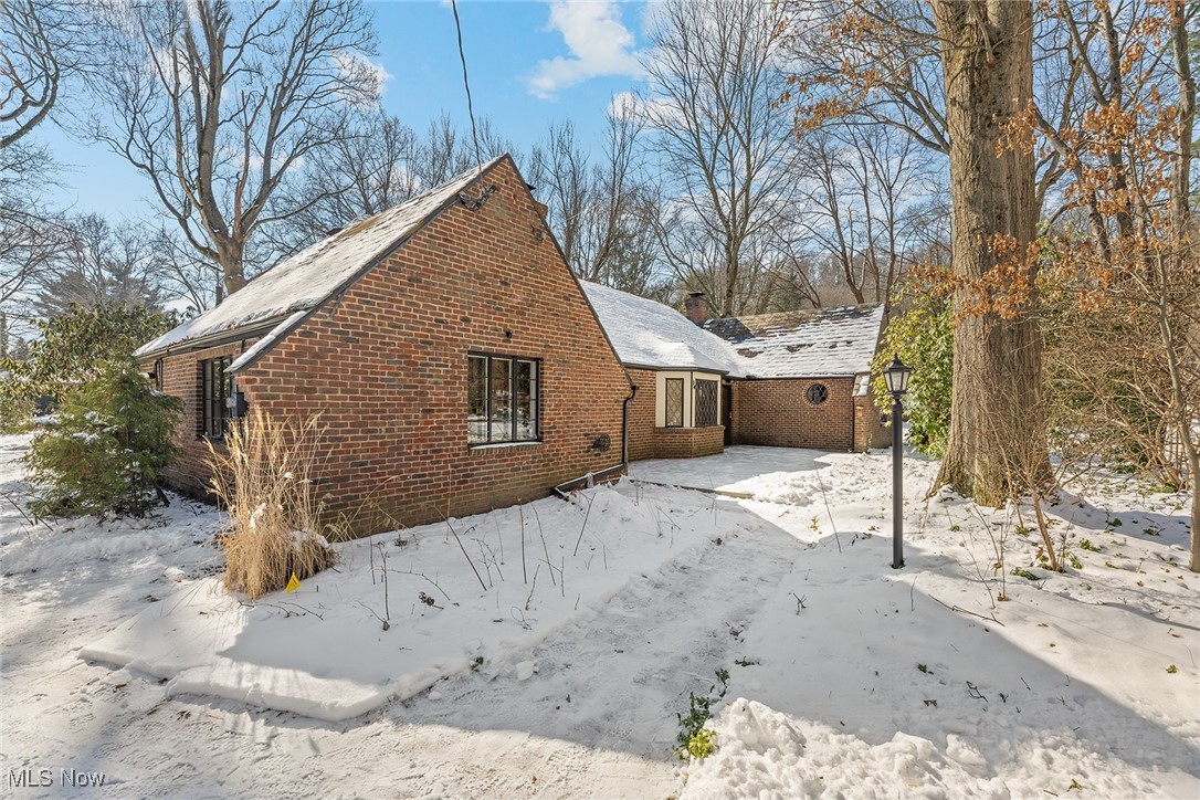 Don't miss this rare opportunity to own an exceptional Kempple home in a tucked-away pocket of West Akron! Old-world charm abounds with a cottage feel that is seamlessly blended with modern amenities nodding to the original Henry Kempple design. This home showcases many of the hand-crafted details the famous architect is known for, including meticulous plaster work, stained glass, beamed ceilings, 2 fireplaces, large iron-framed windows and slate floors to name a few. Dining room/hearth room opens to the fully applianced, updated kitchen. Tucked in the hall is a unique wine nook perfect for your collection. The sunny family room features vaulted ceilings with a catwalk to the loft above and parquet floors. It opens to a private, serene back deck overlooking a fully fenced backyard with a fairy-like garden with mature trees.
Living room with vaulted ceilings and a loft offers ample space and is adjacent to a full bath with walk-in shower and laundry. 3 very spacious bedrooms, one with a walk-in closet and half bath. The hall bath, complete with an original tub and a beautiful stained-glass window, adds to the home’s classic appeal. Radiant floor heating throughout most rooms ensures cozy warmth year-round. Absolutely tons of attic storage space including a workshop area. 2 car attached garage. This is a rare find that must be seen to be appreciated!