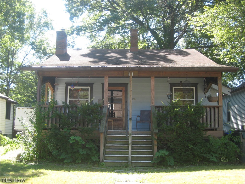 Walk back in time and appreciate the beauty of all hardwood floor, woodwork and trim.  The living room features a stone wood burning fireplace and dining room with parquet ceiling, leaded glass cabinet and window seat. Step saving kitchen has appliances. 2-3 bedrooms and a full bath with tiled tub/shower. Plumbed for first floor laundry and washer and dryer stay.  Unfinished basement has a sump pump, newer furnace and central air (2006).  Welcoming covered front porch, recently rebuilt, perfect for outdoor gatherings, coffee in the morning and wine at night.  Needs a little TLC, but a great little house.