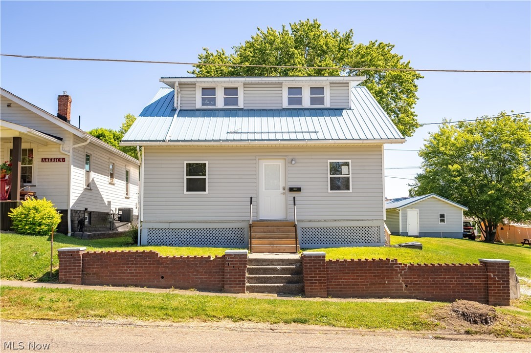 A charming home situated on two spacious lots. Complete with a detached garage and extra driveway space next to house. The property has potential for renovations and sits on top of beautifully preserved hardwood flooring beneath the carpet. Its layout includes two bedrooms on the upper level and one on the main floor, along with an enclosed porch suitable for additional living space. The basement is a walk out basement and has been waterproofed and the warranty is transferable.