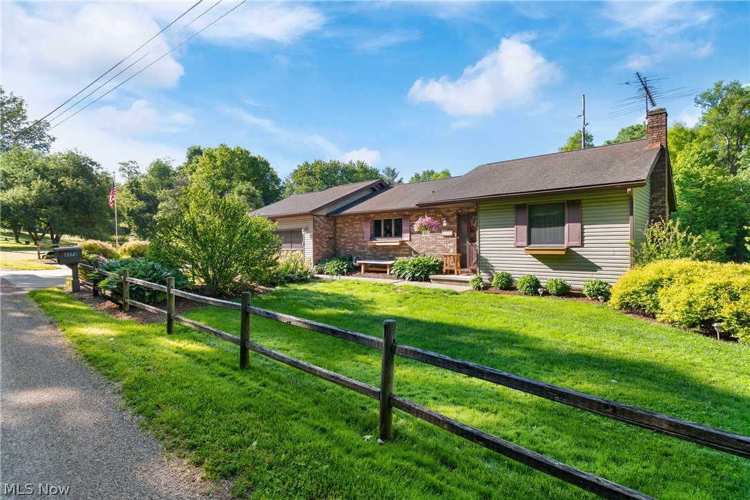 Welcome to 4273 Canal Road, a peaceful country retreat located in the Triway Local School District and nestled on 2.1 scenic acres. This spacious ranch-style home offers the perfect blend of privacy, functionality, and the opportunity to make it your own.   Featuring 3 bedrooms on the main level, this home offers comfortable one-floor living with even more space to spread out in the finished walk-out lower level, complete with an additional bedroom, full bath, and a large family room complete with a wood burner which is perfect for relaxing evenings, entertaining, or hosting guests. You'll also find a small workshop, utility room and storage area that has potential for having a 5th bedroom. Imagine stepping outside from either your living room or private owner’s suite onto the impressive 8x39 deck with gazebo, where you can sip your morning coffee or unwind at the end of the day while taking in your own private outdoor retreat surrounded by nature. The tranquil setting creates the perfect backdrop for relaxation and enjoying the beauty of the outdoors all while just minutes from town. Plenty of updates have already been done including newer flooring, carpeting, painting, appliances, well pump, pressure tank, garage door opener, just to name a few. Outside, the possibilities continue. Dreaming of a little hobby farm lifestyle? This property includes the chicken coop, along with an above-ground pool, trampoline, small storage barn, and wooded areas that offer privacy, recreation, and room to roam. If you’ve been searching for space, versatility, and country charm this property is ready to welcome you home. Seller is including a one-year home warranty! Schedule your private showing today!
