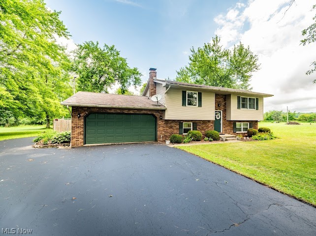Move-In Ready Home with Incredible Garage Space & Private Lot! Welcome home to this beautifully updated 3-bedroom property nestled on a huge, private lot that offers the perfect blend of comfort, style, and functionality. Step inside to discover a bright and inviting living room, a formal dining room for entertaining, and an updated kitchen featuring granite countertops, included appliances, abundant cabinetry, and plenty of storage space. The updated full bath adds modern appeal, while sliding glass doors lead to an expansive multi-level deck complete with a relaxing hot tub ideal for outdoor entertaining or quiet evenings at home.
The spacious lower level serves as a private owner's retreat, featuring a luxurious master suite with a walk-in closet, a cozy family room with a beautiful fireplace and custom built-ins, plus durable and attractive Nature Stone flooring. Outside, you'll find exceptional garage space with an attached 2-car garage and an impressive detached 4-car garage, complete with its own separate driveway and gated access—perfect for car enthusiasts, hobbyists, contractors, or additional storage. Additional highlights include: Beautifully updated interior throughout, Huge private yard, Multi-level deck with hot tub, Vinyl siding for low-maintenance living. Exceptional storage inside and out This one-of-a-kind property offers the space, privacy, and amenities you've been searching for. Schedule your private showing today and see everything this exceptional home has to offer! MOVE IN CONDITION! Get it before it's too late!