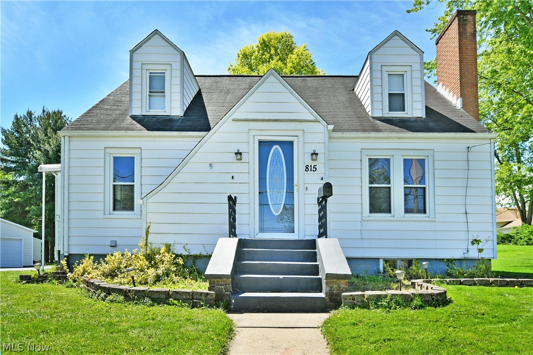 Casual, spacious and full of both natural light and tasteful character, this delightful Salem Cape Cod has all the right moves and more! Located just minutes away from the bustling downtown district, the residence keeps you in close proximity to some of the best hidden treasure restaurants, venues and shopfronts alike. The sizeable lot finds the attractive home sitting elevated from the street with a cement staircase rising from the roadside. The wrapping blacktop driveway continues past the darling sunroom to find both the common rear entry and a large, two car detached garage. Meanwhile, the decorative formal entry opens to find a spacious living room with sunshine spilling across the warm, hardwood flooring, illuminating the stone trimmed fireplace along the far wall. Sculpted entryways continue into the adjacent dining room where elegant hanging lighting creates a welcoming atmosphere. The colorful kitchen provides plenty of downhome, country flare that pairs well with the stainless-steel appliances and contrasting cabinets. Steps away, the relaxing sunroom is sure to be the favorite hangout. Completing the first floor, a sizeable guest bedroom is joined by an engaging full bath. Upstairs, two additional bedrooms include the current master with its built-in shelving. Laundry services are located at the basement level along with a second, oversized full bath.