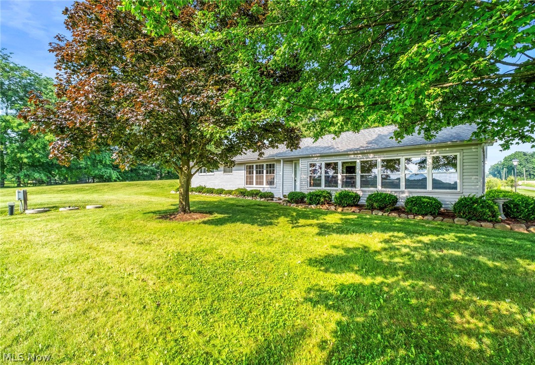 Enjoy the peace and privacy of country living in this well-maintained 3-bedroom, 2.5-bath ranch situated on 2.85 scenic acres. The spacious living room is filled with natural light from the oversized front windows, while the eat-in kitchen offers abundant cabinetry and a functional layout for everyday living. The enclosed sunroom provides the perfect place to relax and take in the beautiful views of the surrounding countryside year-round. The partially finished basement expands the living space with a large recreation area, an additional full bath, and plenty of storage. Outside, the property truly shines with a picturesque pond, mature trees, an expansive yard, and plenty of room to entertain, garden, or simply enjoy the outdoors. An attached 2-car garage completes this move-in-ready property, offering the perfect blend of comfortable living and the beauty of a country setting.