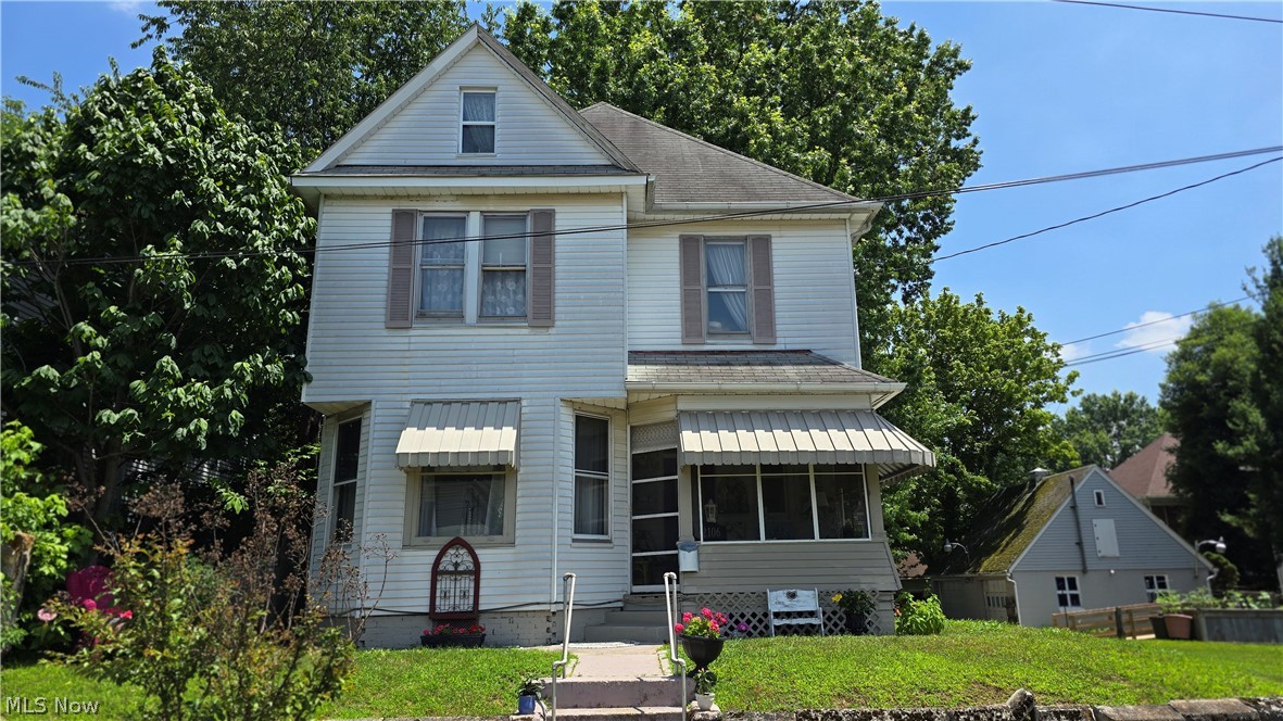 Charming historic home just around the corner from Washington Avenue!  Conveniently located near PHS, city park, and all amenities, this home has an inviting screened in porch for visiting with friends or enjoying morning coffee.  Inside, a large open entry foyer greets guests with beautiful original woodwork.  A front living room is anchored by one of four original fireplaces in the home, and the entire first floor has 9'+ ceilings.  Large pocket doors lead to the dining room which features beautiful original built-ins.  The kitchen is fully equipped with appliances, and accesses both the back porch and a small main level laundry.  Up the grand staircase, the second floor has 2 large bedrooms, a third small room (which could be a nursery, bedroom, office, or walk-in closet), and a full bath.  A fully finished attic makes for another large versatile space for another bedroom, rec room, or storage.  A small basement makes for additional storage and also has secondary laundry hookups.  An alley accesses the oversized single detached garage ensuring comfortable and secure parking, as well as ample storage space.  This charming 100+ year old home is the perfect blend- grand but unpretentious!  Schedule a showing to feel this home's welcoming feel in person!