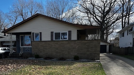 Nicely maintained 3-bedroom, 1.5-bath split-level home offering space, comfort, and great natural light throughout. The large kitchen provides plenty of room for cooking and gathering, while the spacious living room is filled with abundant natural light, creating a warm and inviting atmosphere. Enjoy a formal dining room with patio doors leading to a covered side porch—perfect for relaxing or entertaining. The lower level features a cozy family room with a striking stone wall fireplace and a convenient wet bar, and half bath ideal for hosting guests. Upstairs, you’ll find three well-sized bedrooms and a full bath. Additional highlights include a basement for extra storage or potential living space, a 2-car detached garage, and a private yard.