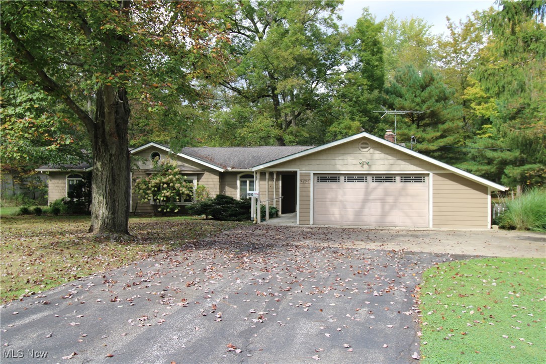 Who doesn't love a charming 1959 ranch nestled on 1.5 lush, wooded acres in the heart of Bainbridge Township, Kenston Schools? This 3-bedroom, 1.5-bath home offers a rare blend of mid-century character and modern comfort. The interior is waiting for your personal touches and decorating ideas. The vaulted ceiling in the family room addition with its prominent wood burning fireplace and mantle could be your spot to decompress after a hard day's work.  Freshly painted in 2024, the exterior is well maintained.  It has a quaint front porch area, but the peaceful views from the enclosed rear porch complete with a hot tub and wood burner, are a site to be seen. Step out onto the deck that runs the length of the enclosed porch to entertain or be surrounded by nature. The property features a heated and air conditioned 32x21 outbuilding that was constructed with a concrete floor with 2" high density foam and 4" of stone for added warmth, a 220 line, a garage bay door, and a porch with lean-to —perfect for a workshop, studio, mancave, she-shed, or extra storage—plus a 10x10 shed for added convenience for your gardening tools etc.  A whole-home gas generator is the "cherry on top" and ensures peace of mind year-round. Don’t miss this private retreat just minutes from downtown Chagrin Falls and the many conveniences it offers!