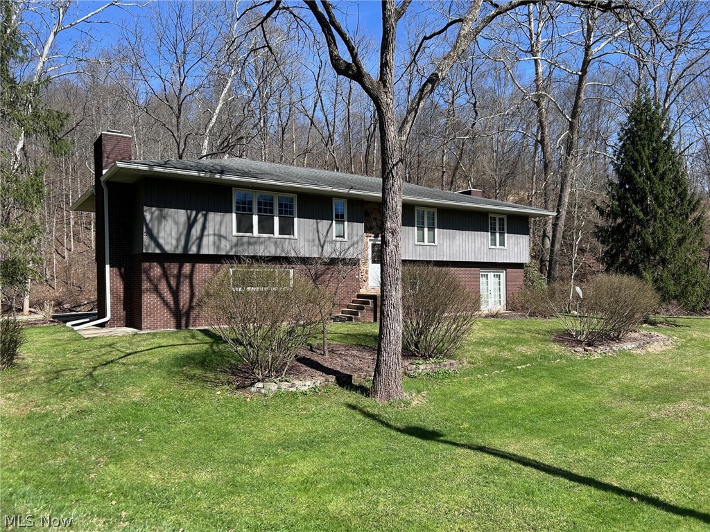 Nestled on 0.75 acres in a peaceful country setting, this 3 bedroom, 3 bath home offers space, comfort, and scenic surroundings. Enjoy the sights and sounds of a flowing creek from the oversized back deck—perfect for relaxing or entertaining. The main level features an open living and dining area with a cozy fireplace, along with a private office just off the entry. The eat-in kitchen offers an abundance of cabinetry, Corian countertops, a desk area and French doors leading to the deck. The primary suite is a true retreat, complete with its own fireplace and private deck access—ideal for unwinding with creek views. The en-suite bath features a jacuzzi soaking tub. The finished lower level expands your living space with an oversized family room, additional fireplace, wet bar, and French doors opening to a lower patio. A spacious full bath with laundry adds convenience. Additional highlights include a two-car garage with abundant cabinet storage.  A rate opportunity just minutes from downtown!