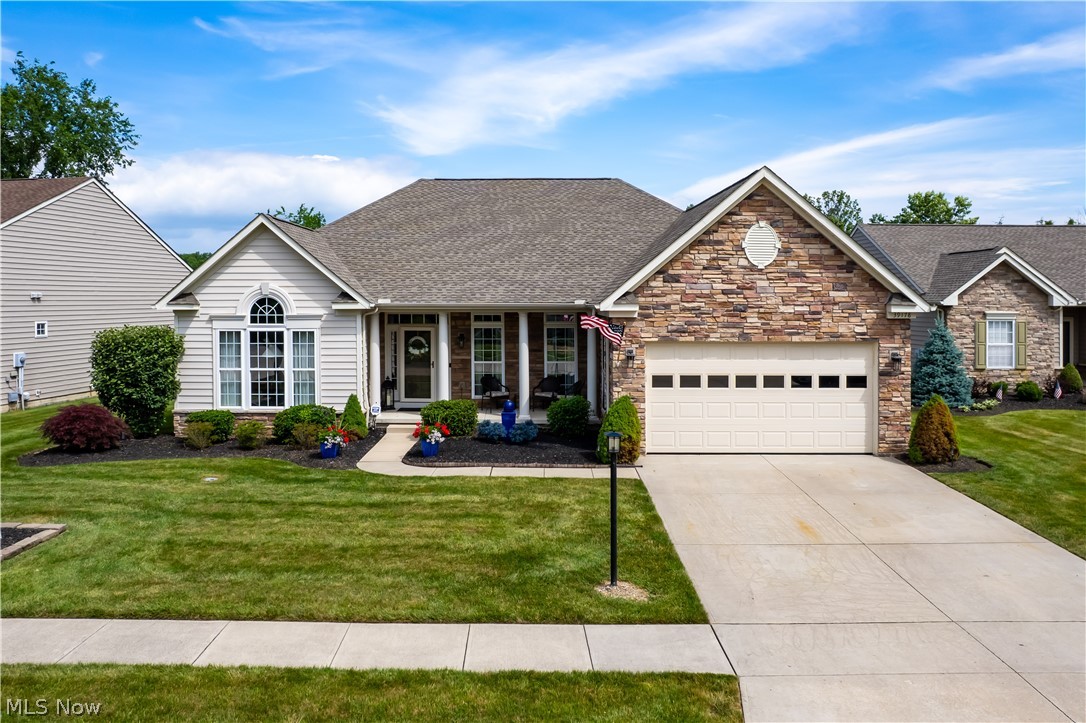 Experience the perfect blend of luxury, space & convenience in this exceptional ranch home located in Orchard Trail's low-maintenance community. Offering over 2750 sqft on the main level, this well maintained residence is ideal for those looking to downsize without sacrificing entertaining space, storage, or the furnishings & lifestyle they love. This 3 bed, 2 full, 2 half bath home welcomes guests with abundant natural light, and new engineered handscraped maple floors that flow through the main living areas. The great room has a stone fireplace framed by oversized windows. The kitchen features marble countertops, newer stainless steel appliances, abundant cabinetry, butler’s pantry and flows into a bright sunroom. A sliding glass  door leads to the outdoor deck & patio. Designed for privacy, the primary suite occupies its own wing of the home and features a lit tray ceiling, walk-in closet & luxurious ensuite bath complete soaking tub & separate shower. Two additional bedrooms are situated on the opposite side of the home paired with the main bathroom. At the front of the home, the den has French doors & cathedral ceilings. The formal dining room accented with a tray ceiling & chair rail. Convenient laundry room & guest powder room complete the main level. Downstairs, the basement offers flexibility with a full kitchen, half bath & extensive storage space, making it ideal for future expansion. Outdoor living takes center stage with a Trex deck with waterfall stairs that lead to a stunning custom-covered stamped concrete patio featuring dramatic timber beams, rustic sliding barn doors, a beadboard-style vaulted ceiling, recessed lighting, and ceiling fan all overlooking tree-lined greenspace. Major updates include: wrought-iron staircase spindles, new carpet in the primary suite & closet, HVAC with energy efficient heat pump & gas inverter (2024), roof (2024), and new garage rails, garage door, and opener. Come see today!