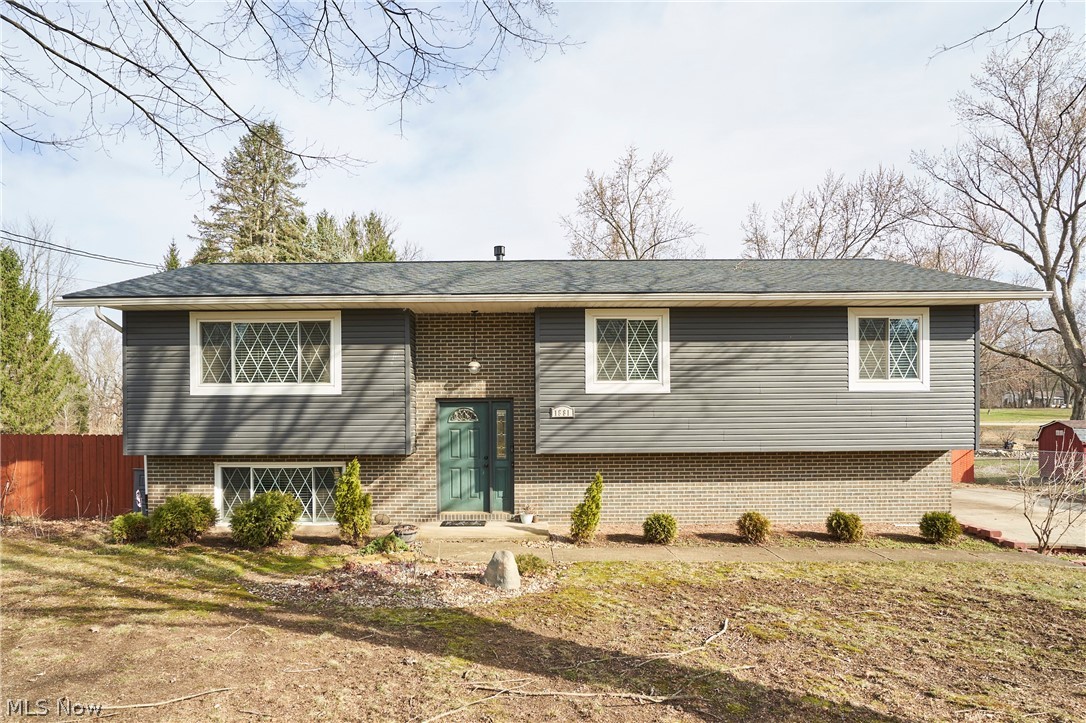 **OPEN HOUSE SUNDAY 2-4** Welcome to this beautifully updated 3-bedroom, 2.5-bath home set on a .53 acre landscaped lot. The exterior features new siding, a new roof, and updated windows for added peace of mind. Inside, enjoy a bright open layout where the living room, dining room, and kitchen flow seamlessly together—perfect for everyday living and entertaining. The kitchen offers granite countertops, a stone sink, all appliances included, and a distinctive live-edge bar. Sliding doors lead to an impressive two-tier deck overlooking the spacious backyard with a storage shed. The home features generously sized bedrooms with new flooring, including a primary suite with a private bath and luxurious two-person shower. The main bath has been beautifully remodeled and includes a jetted tub. The walkout lower level provides a cozy living space with a gas fireplace, laundry area, and access to the attached garage. Recent upgrades include a tankless hot water heater, covered patio, stamped concrete patio and walkway, new upper deck with vinyl railing, and a fully fenced backyard with multiple entry points.