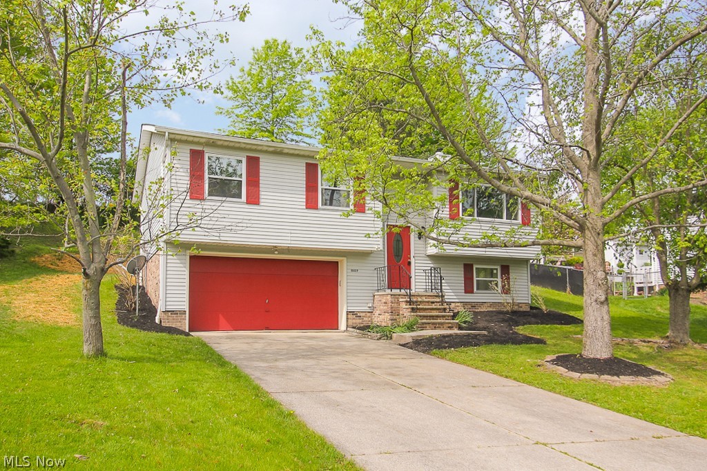 You'll find yourself captivated by this Move In Ready recently updated home. As you enter you'll notice the brand new carpeting and vinyl plank flooring throughout. The kitchen has been made chef ready with its brand new top brand named Stainless appliances. Enjoy a cozy warm fire during those cold Cleveland nights by your brick surrounded gas fireplace. The lower level is a great place for entertaining.  Enjoy time with friends or family barbecuing out on your brand new wood deck right off of the dining room. Much of the low maintenance backyard has been recently seeded with new grass.Washer and Dryer Hookups available in the laundry room. A one year home warranty has been provided to the buyer by America's Preferred Home Warranty.