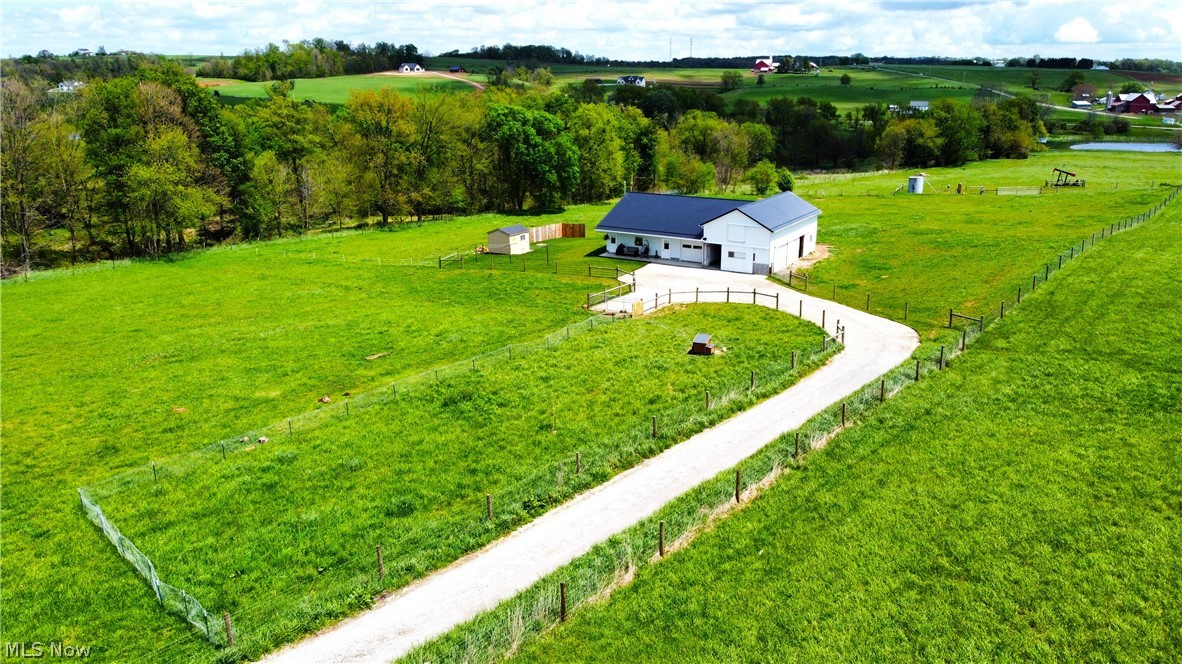 Hard-to-find acreage in a prime location between Mount Hope and Mount Eaton, Ohio—this 8½-acre property offers the perfect blend of functionality, seclusion, and potential. Featuring a well-equipped barn and shop with living quarters, the property includes natural gas, water, septic, and established pasture all in one package. The living space offers one bedroom, one bath, a comfortable living room, and a kitchen area, along with a separate washroom for laundry, a buggy space, and a convenient entranceway. The barn includes three stalls and is surrounded by ample pasture, ideal for livestock or hobby farming. A small wooded area at the back provides a peaceful spot for kids to play or to enjoy nature. Whether you’re looking for a starter property or the perfect foundation to build your dream home, this unique offering is set up to become an absolute gem in a highly desirable area.