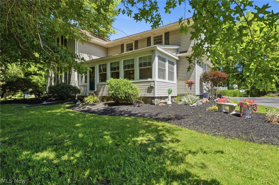 Character and care are bursting from this well appointed colonial home. Located a stones-throw from marinas and just outside of Vermilion’s downtown historic district, there may be no better place to call home! Whether you’re boating to the flats, Put-in-Bay, gone fishing or yearning for a simpler life, it’s all made possible here! The home is set back off the road and shaded by mature trees. Entering through the sunroom in the front of the home, a calm arrives immediately. A beautiful picture window keeps the room connected with the rest of the home while the windows across the front and side keep you connected to nature. The large dining room is open to a spacious kitchen, creating the heart of this opened up floor plan. Timeless kitchen cabinetry boasts old-world quality while a newer breakfast bar has been added to aide to large gatherings and daily functionality. The living room is also large and features beamed ceilings. Original wood floors and high ceilings compliment both the living and dining rooms as well! A first floor family room with modern plank flooring offers potential for use as an office or bedroom and it is just steps away from a full bath! The first floor also has a laundry room with extra space for storage AND additional storage found just outside of it, offering convenience from the rear entry of the home. Upstairs plays host to three bedrooms, all with surprisingly big closets for this style of home! A full bathroom that has been tastefully renovated completes the second level. Newer replacement windows are found throughout this well maintained home. The roof and gutters are 4 years young with a long life rubber membrane used where appropriate. HVAC was replaced in 2016. The yard offers plenty of open and usable space while the wooded backdrop provides privacy and shade. The outbuilding is ready to keep your lawn equipment and storage dry through all seasons! Come and see this home today! All kitchen and laundry appliances will stay.