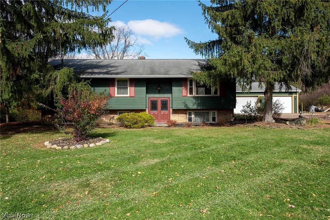 Welcome to this well-cared-for 3-bed, 2-bath bi-level property with loads of rustic charm on a beautiful 1.6 acres near The West Woods. Enter through the newer, double front doors and head up the stairs to the main living area with cozy sitting room before moving into the bright and spacious eat-in kitchen. Featuring dual access to the home's newer back deck, plenty of cabinet and counter space for all of your food-prepping needs, and a stylish linoleum floor for easy clean-up, this kitchen is sure to please any entertainer. Finishing off the upstairs are 3, well-sized bedrooms and a beautiful full bath with decorative tile surround and wood-look flooring. Moving downstairs, the home offers a perfect opportunity for an in-law suite or rental potential with another full bath, a sitting area with wood-burning fireplace, and a room that could function as a 4th bedroom. The basement area is equipped with a kitchenette and includes a double sink and 2nd stove along with the home's washer an