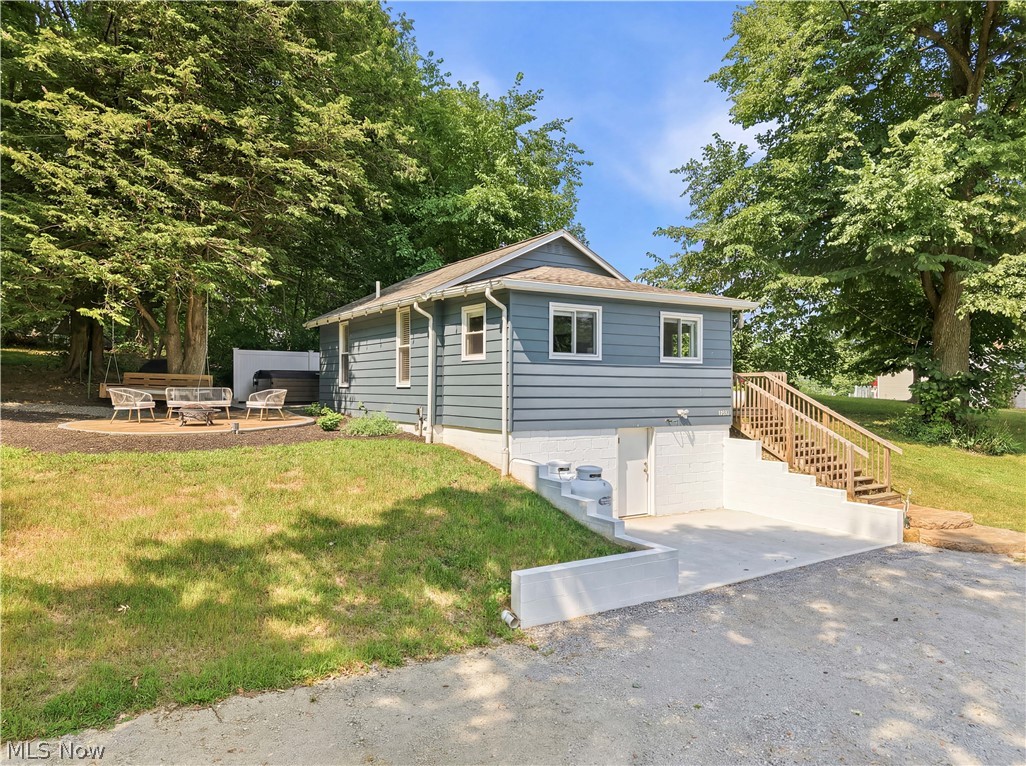 The cutest little cottage at Guilford Lake has just become available! Perched on a hillside overlooking the water, this beautifully remodeled home offers breathtaking lake views and the perfect blend of charm, comfort, and modern convenience. Completely renovated from floor to ceiling within the last two years, this move-in-ready home features 2 bedrooms and 2 full bathrooms. Designed for easy, efficient living, everything you need is conveniently located on the main level, including a stackable washer and dryer. The stunning kitchen showcases black stainless steel appliances, new cabinetry, and custom concrete countertops, while the beautifully updated main bath features a custom tiled walk-in shower that feels straight out of a spa. Step outside to discover where this property truly shines. The elevated concrete patio creates the perfect setting for entertaining while you relax in your very own hot tub. Continue into the side yard, where an oversized 8-foot swinging daybed is tucked beneath a shady tree, creating the ultimate spot for an afternoon nap surrounded by nature. A massive fire pit brings the outdoor spaces together, making this an ideal place to gather with family and friends. An outdoor storage shed provides room for your lake toys, tools, and outdoor equipment. Access to the lower-level basement is located outside. This space houses all of the home's updated mechanical systems, another full bathroom, and an additional laundry area complete with a washer and dryer. There's also ample parking, making hosting guests a breeze. Currently operating as a successful Airbnb, this property has performed exceptionally well for the current owners, perfect for an investor looking to expand their portfolio. Whether you're searching for a profitable short-term rental, a relaxing seasonal getaway, or a full-time residence with unforgettable lake views, this charming cottage checks all the boxes. This just might be the one you've been waiting for :)
