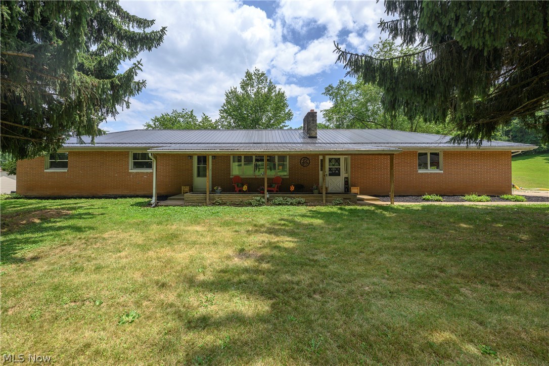 Tucked away on a quiet, peaceful street, this beautifully updated 4 bedroom ranch sits on a 1 acre lot, offering the perfect blend of country privacy and modern convenience. Nearly every major system in this home has been refreshed or replaced within the last 5 years: a brand-new HVAC system, a new water softener, a durable metal roof, and a newly updated septic system. Inside, the interior shines with fresh paint, new flooring, new lighting, and brand-new drywall where it counts. The main level offers a highly functional layout, featuring a bright living space and a convenient first-floor laundry room located right in the breezeway. The kitchen has been refreshed with new paint, updated counters, and stainless appliances to stay. The comfortable bedrooms include a primary suite equipped with its own private half bath, and completely refreshed full bath for guests and kids. Need space for entertaining or an in-law suite? The partially finished walkout basement is a massive bonus! It features a large, cozy rec room perfect for movie nights or game days, along with a second full kitchen space that makes hosting an absolute breeze. The sunroom makes a perfect transition to summer living where indoor and outdoor entertaining combine. Enjoy summer nights around a fire or pop up a pool & entertain for hours. For daily parking, the home features a convenient attached 2-car garage. Beyond that, the exterior setup is a dream for hobbyists, mechanics, or anyone needing serious storage. The property boasts a massive, detached 32x70 shop building complete with its own dedicated heating and air conditioning system, allowing you to work comfortably on your projects all year round. Don't miss out on this rare find! Properties that offer this level of acreage, extensive updating, and a massive climate-controlled shop do not come along often. Schedule your private showing today!
