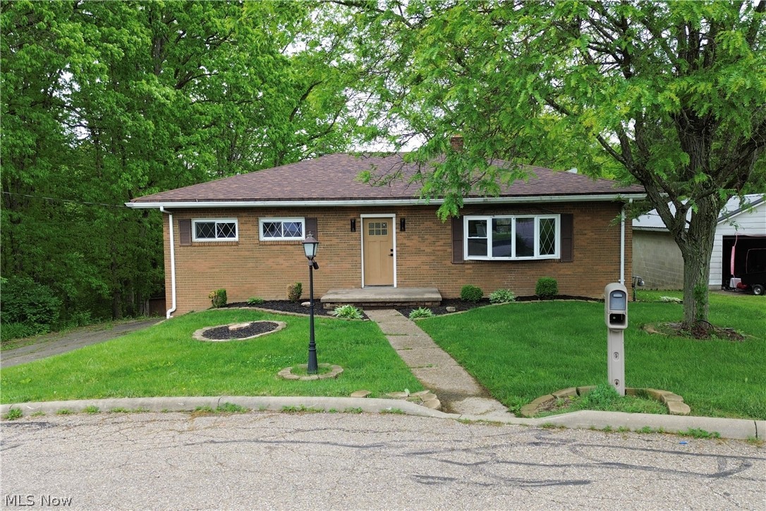 Completely updated from top to bottom, this 3 bedroom, 2 full bath brick ranch is located on a quiet cul-de-sac in the heart of Wintersville near many local amenities. Situated on a large scenic lot with a private wooded backdrop, this home offers move-in ready living with modern updates throughout. The open-concept main level features a spacious living area with updated flooring and lighting, flowing into the brand new kitchen with soft-close cabinetry, granite countertops, and a clean modern design. The main level full bath has been completely renovated with custom tile work and updated fixtures. Spacious bedrooms and large windows provide plenty of natural light throughout the home. The finished basement adds an incredible amount of additional living space with a large rec room, fireplace, updated full bath, and extra room for entertaining or office space.