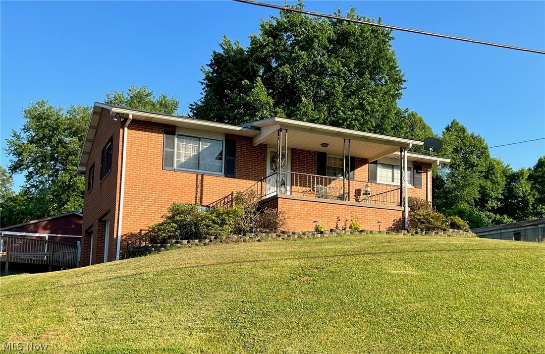 This three bedroom. 1 and 1/2 bathroom brick raised ranch, situated on three lots has so much to offer.  Main floor features three bedrooms, living room, eat-in kitchen and family room.  Lower level includes a 23' x 12' room with painted concrete floor and a large-shelved storage closet.  Basement space is a crafter's dream.  There's a two-car garage under the home.  Step outside to summer fun.  Inground pool with large deck welcomes you to relax.  But wait, there's more.  There's a huge 3-car building for all the "toys".  Don't wait.  Make this your new home!