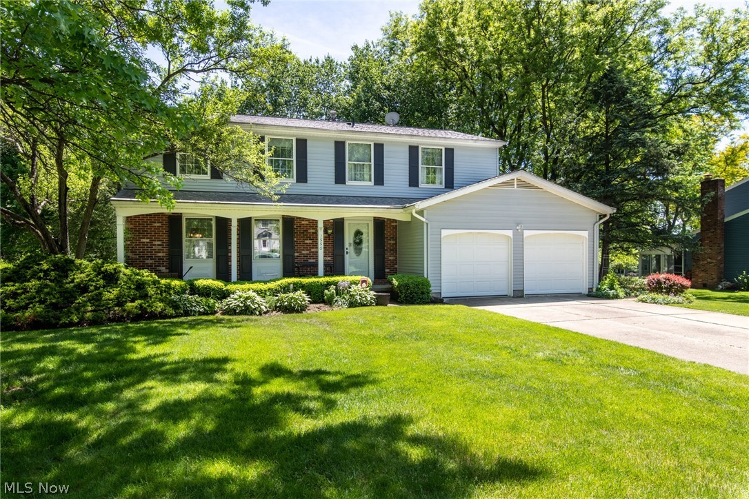 Welcome to this charming 4 bedroom 2 1/2 bath Colonial in the desirable community of Hudson! Spend warm summer nights on the front porch or brick patio in the private back yard. Spacious living room and formal dining area. Large kitchen with quality oak cabinetry, wood flooring, and center island opens to a cozy family room with fireplace and sliders leading to the paver patio. Light and bright sunroom off of dining room. The second floor master bedroom features and en suite master bath. Three additional sizable bedrooms and an additional full bath complete the second level. Finished lowered level rec room with nature stone flooring. Two car garage. Well maintained and a fabulous opportunity! Close to downtown Hudson shopping! Call for a private showing today! Welcome Home!