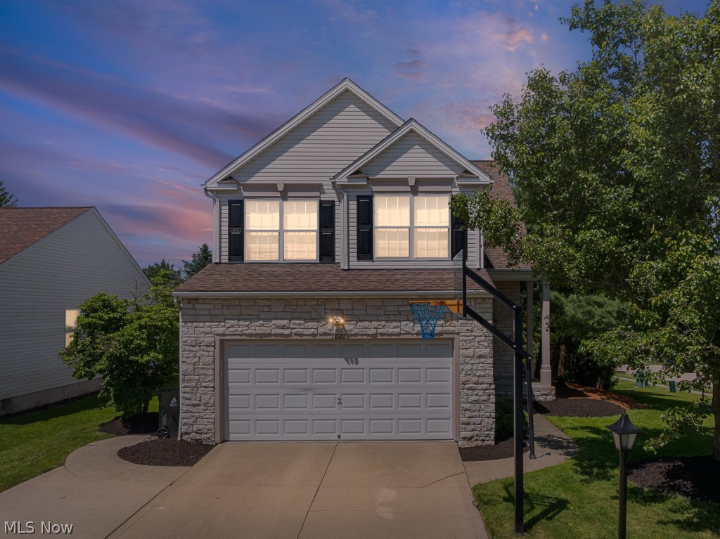 Welcome home to 1021 Ledgestone Drive in Wadsworth! This beautiful Colonial is situated on a professionally landscaped corner lot in the highly sought-after Weatherstone Development. Offering over 2,200 square feet of living space, this stunning home combines elegant updates with a warm, inviting layout designed for both everyday living and entertaining.

A charming covered front porch welcomes you inside, where you'll immediately appreciate the impressive two-story great room featuring beautiful hardwood flooring, fresh professional paint, a gas-start fireplace, and a dramatic floor-to-ceiling stone surround. The updated kitchen is sure to impress with gorgeous granite countertops, beautifully refreshed cabinetry with under-cabinet lighting, stunning 24x24 tile flooring, and a striking stone accent above the gas range hood that perfectly complements the fireplace design. The open-concept layout provides seamless flow and abundant natural light throughout the main living areas.

Upstairs, the spacious owner's suite offers vaulted ceilings, a walk-in closet, and a private bath, creating the perfect retreat at the end of the day. Two additional generously sized bedrooms and a full bath complete the second floor.

The partially finished basement provides valuable additional living space, ideal for a recreation room, home office, fitness area, or playroom, along with a separate laundry room for added convenience.

Step outside and enjoy the beautifully maintained landscaping, a stamped concrete patio perfect for entertaining, and access to a peaceful common green space that enhances the property's serene setting. A 2-car attached garage and exceptional curb appeal complete this remarkable home.

As an added bonus, Weatherstone residents enjoy access to a community clubhouse featuring a fitness center and an inground pool—just in time for summer! This exceptional property won't last long. Schedule your private showing today!
