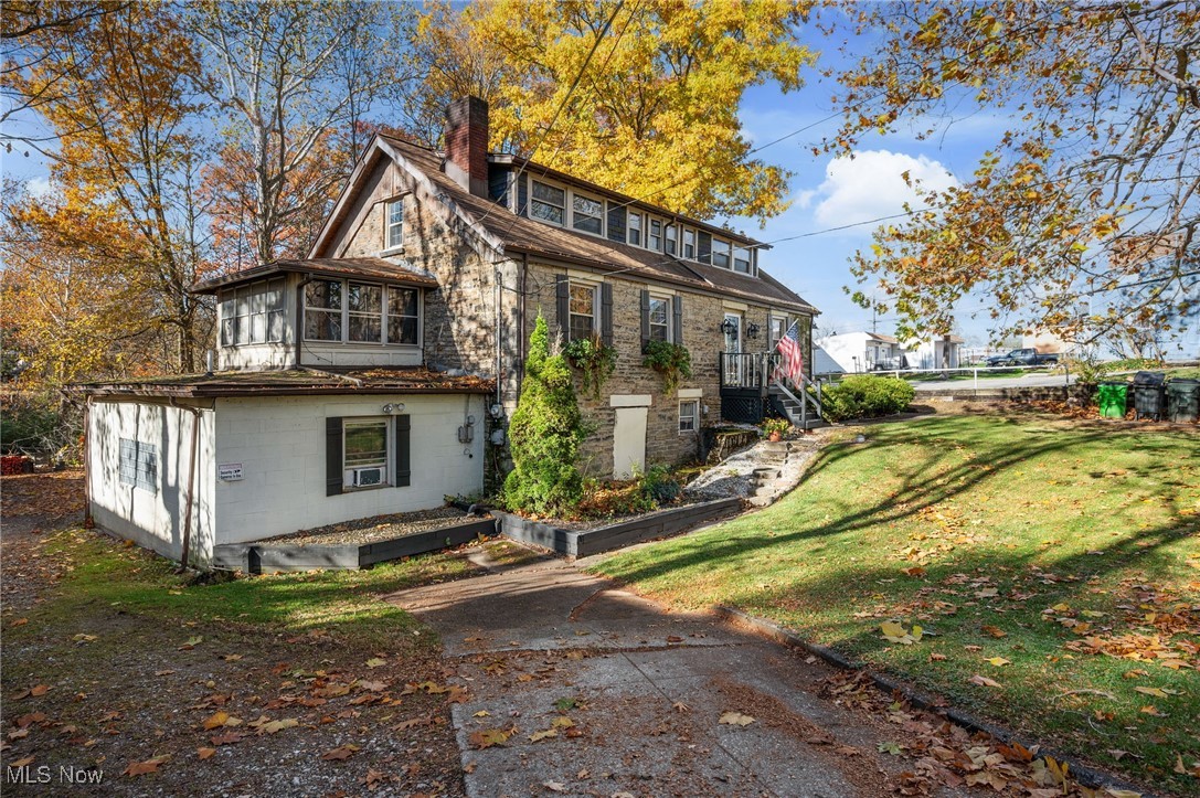 Profitable Investment at 920 Broadway Ave., Bedford OH 44146. Zoned B-2 General Business and Full Occupancy with Almost 3,000 sq. ft., on over a half-acre with beautiful view of Tinkers Creek!  Built in 1832 as a tannery and the second floor added years later was made into a rooming house with all the permits and inspections required by the City of Bedford.  The property is a certified rooming house by the City of Bedford, with renewal every January.  Presently has 9 rooms, an apartment efficiency on the ground floor and the separate entrance apartment (total of 11 units).  Approximately 15 years ago, city passed an ordinance that restricted any further rooming houses and grandfathered this one.  Rooms have a refrigerator/freezer, microwave, with 5 having in window air conditioners.  Each has a bed, (mattress/box spring), furniture, and TV.  Owner pays spectrum for Wi-Fi, if tenant wants cable they must pay for it, two at present time, the two are billed monthly.  Full kitchen, stove, freezer, and eating area and a large living room. Parking lot has 9 spaces, two sheds, and a fire pit.  Tenants are month to month.  Each floor has a full bath with shower.  Located 15 miles to downtown Cleveland, 20 miles to Cleveland International Airport and within a mile of shopping, grocery, clothing, and restaurants.  Public water and Public Sewer.  Don't miss your opportunity to own investment today! First time investors to portfolio investors, a lot of potential with the addition of this rooming house. Cleveland, OH!