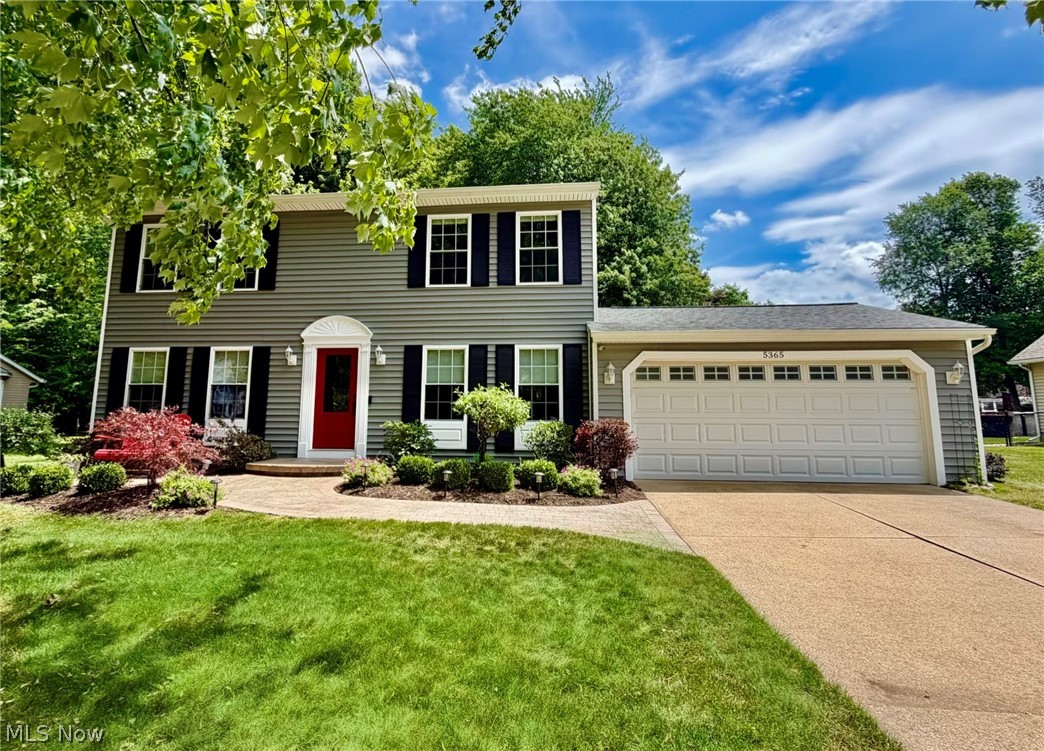 Pristine Center Hall Colonial in North Mentor! This impeccably maintained home has been thoughtfully updated and upgraded throughout.  As you step into the front foyer you are greeted by gorgeous Patagonian rosewood floors that carry through the entire first floor. The kitchen offers ample granite countertops, cherry cabinets, a roomy pantry, sliders leading to the patio and a breakfast bar that faces the family room- great additional seating for watching the BIG game.  The family room offers a stately, wood-burning fireplace and a large bay window for viewing the scenic back yard.  The dining room has ample space for entertaining and built-in display cabinets with soft lighting.  The updated powder room and cozy living room complete the first floor.  Upstairs there are 4 good-sized bedrooms, a tastefully updated hall bath with tub and a primary bedroom with updated ensuite bath.  The lower level has a laundry/workshop/ storage space on one side and an unfinished rec space that can be finished for endless possibilities.  Out back is a lush, semi-private yard, a newer shed and newer concrete patio. A 2 car garage, a Generac generator, and professional landscaping complete this lovely home.  Updates include: All Doors, Windows, Furnace, Siding, Gutters, Baths, Wood Flooring, Baseboards and Trim, DW, Range, Washer, Dryer, Garage Door Opener, Shed, Patio and Pavers, HWT, Custom Blinds and more. Located in a quiet neighborhood near Blackbrook Golf Course and Mentor Marshes.  This is a must-see! Check out our 3D Tour and call for your showing today!