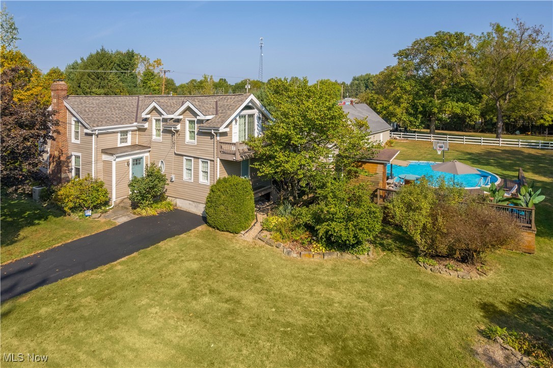 Welcome to your private retreat!
This beautifully updated 4-bedroom, 3-bathroom home offers the perfect blend of comfort, style, and entertainment—both inside and out.

Step inside to find a fully remodeled kitchen with modern finishes with tons of cabinet space, granite counter tops, stainless appliances and a huge island, the kitchen is perfectly finished off with a custom slate floor. Enjoy the large living room with it's brick fireplace on those long winter days the first floor is finished out with a spacious first-floor master suite complete with walk-in closet and spa-like bathroom, head up stairs for a second a cozy family room featuring its own wet bar vaulted ceilings and balcony. 3 guest bedrooms finish out the second floor. Large windows throughout fill the home with natural light, all recently replaced, add in the new roof for efficiency and your peace of mind.

Outdoors, the property is an entertainer’s dream. Enjoy a covered pavilion with a gas fireplace, and even a pool with a natural gas heater and poolside deck and it's very own tiki bar!—perfect for summer fun or quiet evenings by the fire. An outdoor wet bar with electrical service makes hosting effortless, while two additional outbuildings provide plenty of storage and work spaces.

Sitting on almost an acre, this home truly has it all—space, upgrades, and endless opportunities to relax or entertain. Don’t miss your chance to own this exceptional property!