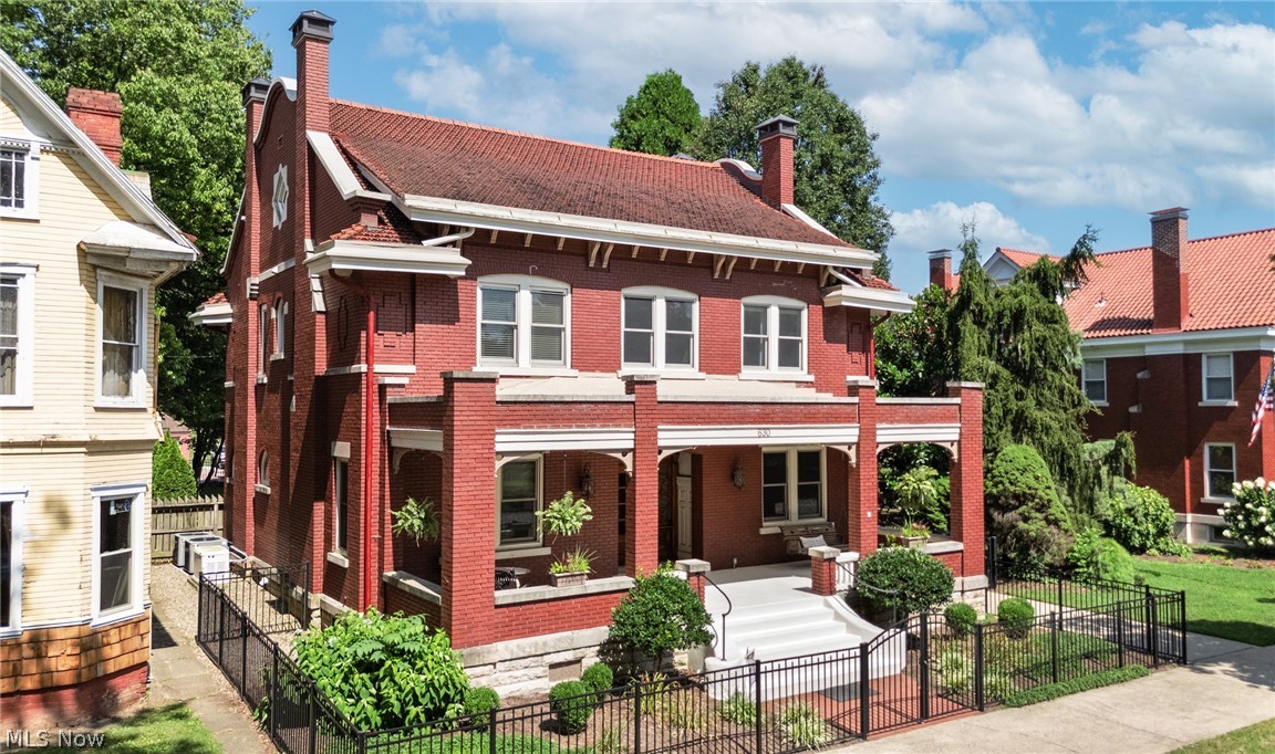 Step into timeless elegance with this gorgeous all-brick 5-bedroom, 4 bath Georgian Revival home located in the heart of Marietta! Rich in character and craftsmanship, this stunning property showcases solid oak flooring and trim, soaring ceilings, rounded corners, stained glass windows, and a classic Spanish tile roof. A grand entryway welcomes you into the large family room offering a cozy fireplace and functioning pocket doors, while the inviting sitting room features an ornate fireplace and built-in vault. The custom eat-in kitchen features stainless steel appliances, decorative lighting, abundant cabinetry, built-in beverage cooler, and plenty of space for gathering. A convenient mudroom off the kitchen includes a built-in desk nook. Upstairs, a spacious landing connects generously sized bedrooms, two with fireplaces. The primary suite boasts an updated en-suite bath with custom tile work, Kohler steam shower with stereo, and jetted soaking tub. Bedroom two also includes an updated private bath. A well-appointed laundry room offers a wash station, ample storage, and an oversized walk-in closet. The fully finished attic provides exceptional bonus space complete with modern lighting and an office area. Outdoor living is equally impressive with a back porch featuring custom built-in storage and a SunSetter retractable awning, plus an expansive paver patio with decorative wall and hot tub nook (hot tub included). Additional highlights include separate guest quarters above the garage with dedicated parking, whole-house Generac generator, gated electronic driveway access, side-entry carport, and a 3-stall garage with rear drive-through access to the alley. Close to schools, hospitals, shopping and dining. This extraordinary home blends historic charm with modern luxury in one remarkable property! Don't wait - schedule your showing today!