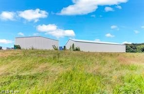 EXCELLENT LOCATION for your next business opportunity! Situated on 5.0 acres of land just on the outside of Minerva Ohio, this property is currently zoned C-480 and is currently home to a pallet business in which the owner is dissolving. Features include a 60 x 80 metal building, with PHASE 3 ELECTRIC, fully insulated with a cement floor, and a wood stove heat. Large overhead door in the back of the building allows a semi-truck to access. Another 100 x 60 metal building needs some finishing touches and currently does not electric ran to it. Currently no water or sewer but city water is close by. Owners are retaining mineral rights will transfer surface rights.