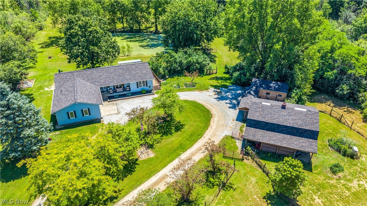 A true DREAM PROPERTY situated on nearly 5 acres in Medina! This 3-bedroom, 2.5-bathroom RANCH HOME has been thoughtfully renovated over the past four years under the direction of its current owners. Set far back from the road, 6827 Wooster Pike offers a park-like setting with two expansive pastures — ideal for pets and homestead animals. This property has exceptional amenities, including a two-story barn with water + electric and an additional detached garage—both recently updated with new roofs. Enjoy the versatility of open, level land and a natural pond that attracts abundant wildlife. The home's exterior has been updated handsomely w/ NEW ROOF AND SIDING (2023). Inside, you will find a COMPLETELY RENOVATED KITCHEN including new cabinetry and GRANITE counters, Samsung smart appliances, and pantry. All three bathrooms have been renovated by the current owners including the ensuite primary bathroom. All three bedrooms, a dedicated dining area, living space, and laundry area are also included on the first floor - TRUE ONE FLOOR LIVING!! A FULL, WALK-OUT BASEMENT is partially finished and has space for the perfect workshop, exercise room, pantry and/or storage areas.  Additional updates include: new roof/siding (2023), 50 gallon hot water tank (2022), central air (2015), furnace (2019), electrical panel replacement/upgrade (2022), updated multi-stage water filtration & softener (handling sediment, iron, and microbes - 2022), gutters/downspouts (2024-2025), and so much more! Located in highly desirable Medina City Schools and Montville Township (no local taxes!!) Schedule your showing today to experience the BEST Medina County has to offer!