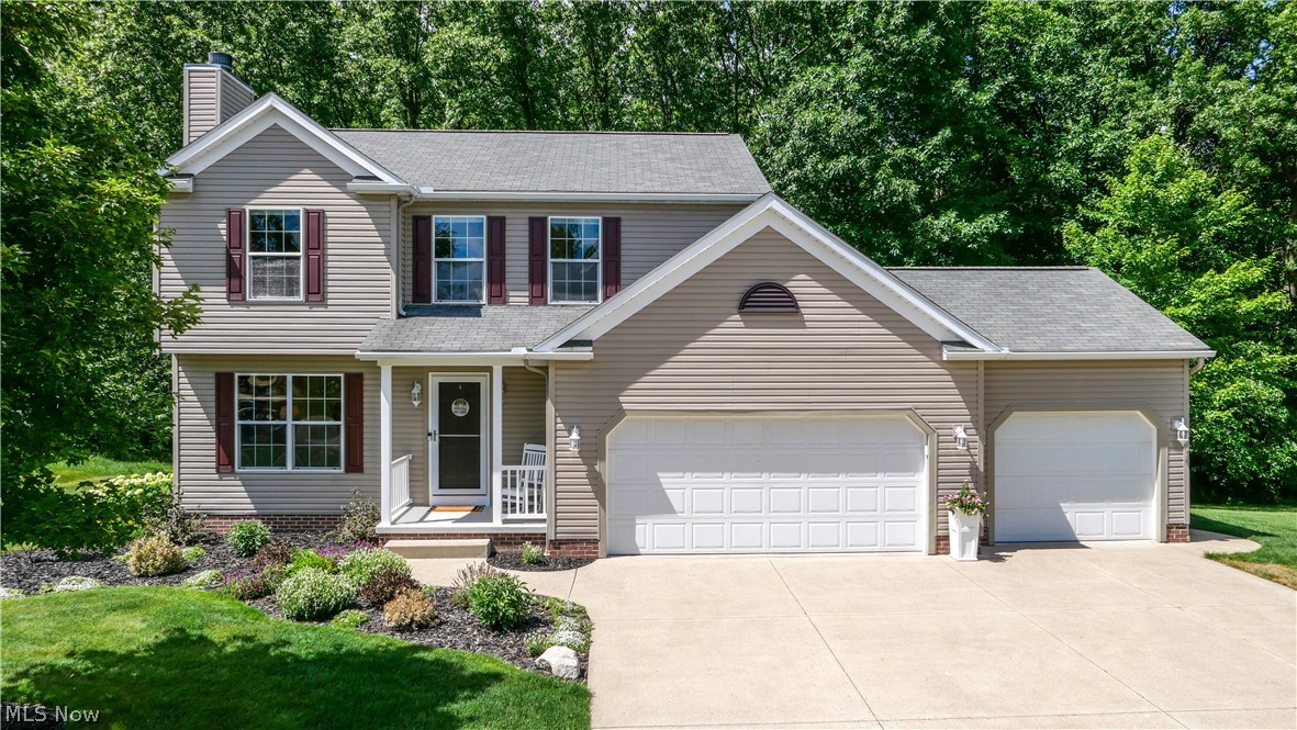 Welcome home to this beautifully maintained 3-bedroom, 2.5-bath Colonial, nestled on a spacious .54-acre wooded lot near the end of a quiet dead-end street in Timber Run. Boasting a rare attached 3-car garage, this 2006-built home offers 1,602 square feet of bright above-ground living space, plus an additional 450 square feet of finished walk-out lower level, totaling 2,052 square feet of finished living space.

The inviting main level features a seamless blend of luxury vinyl plank and carpet. Relax by the cozy stone gas fireplace in the main living area or enjoy the convenience of the first-floor laundry room. The eat-in kitchen comes fully equipped with granite countertops, a gas range, a built-in microwave, a refrigerator, and ample cabinet space.

Upstairs, the generous primary suite serves as a retreat, complete with a walk-in closet and a private bath featuring a granite countertop, soaking tub, and shower. Two additional bedrooms and a second full bath provide comfortable, flexible space for family or guests.

The finished walk-out basement adds 450 square feet of versatile living space—perfect for a recreation room, media center, home office, or gym—with direct access to the backyard.