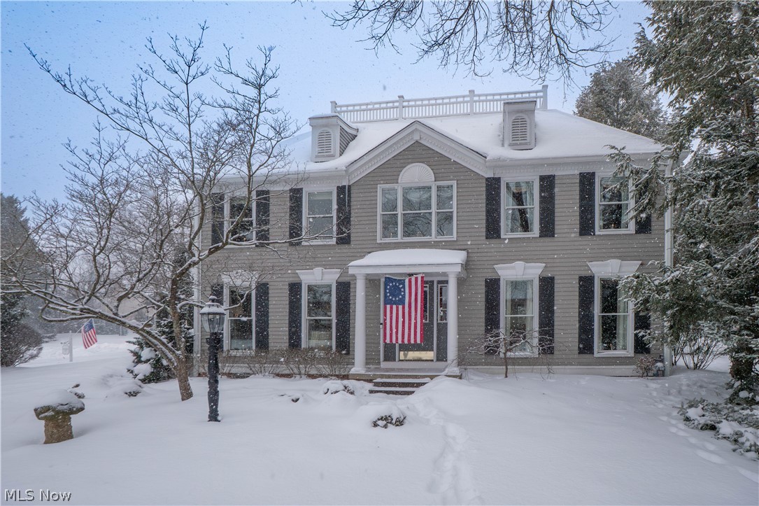 Welcome to this classic Colonial nestled on a quiet cul-de-sac in the desirable Bob O’ Link Estates of North Canton. From the moment you arrive, you’ll be drawn in by the home’s inviting curb appeal, welcoming front porch, and beautifully maintained setting. Inside, a gracious foyer sets the tone, flanked by a cozy library/study with floor-to-ceiling built-in bookcases—perfect for a home office or quiet reading retreat. The formal dining room offers an ideal space for gatherings and holidays, while the heart of the home is the expansive, well-appointed kitchen featuring granite countertops, abundant cabinetry, a large center island, breakfast bar, dual sinks, double ovens, and a charming sitting area with a gas fireplace. Just off the kitchen, a warm and inviting living room with hardwood floors and a second fireplace provides a comfortable place to unwind. A first-floor laundry room and half bath add everyday convenience. Upstairs, the spacious primary suite offers French-door access to a private bath with soaking tub, seated vanity, and generous walk-in closet with built-ins. Three additional bedrooms and a full bath complete the second level. The partially finished lower level adds flexible living space with a recreation room and dedicated office area. Step outside to enjoy the fenced backyard oasis featuring a large pond with fish and waterfall—an ideal setting for relaxing or entertaining. Additional highlights include Pella windows, a newer roof, attached two-car garage, and a prime location close to schools, parks, and amenities. A truly special home offering space, quality, and timeless charm.