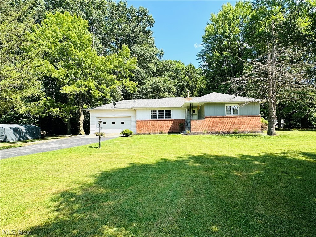 WOW!!....Country charmer in Newton Falls! You’re gonna love this 3 bedroom, 1-1/2 bath ranch with over 1-1/2 acres and a huge corner lot that is ready for you to move right in! As soon as you pull in the driveway, you’ll love your fresh landscaping w/lots of mature trees and enough room for your kiddos to 4-wheel or go golf carting for days!  Your huge driveway has a pull off and a turn around which is great if your family owns lots of cars, trucks, or recreational vehicles!  Your large storage shed in the backyard can fit your mowers, kids toys, and gardening equipment.  You're gonna love sipping your morning coffees on your back patio watching turkey, rabbits, and deer walk through your very own Nature Retreat!...Ahhhh.....Peace and quiet at last!!  Mom will love her updated kitchen w/newly resurfaced formica countertops which has tons of cabinet and drawer space to fit all those crock pots and cooking utensils!  EXTRA BONUS:  Your new home has a huge addition in the back which gives you a 500 sq/ft second living area, has a fireplace, and a convenient 1/2 bath!  This addition completely changes the "traditional" ranch layout giving you so many more options for this great space!  Use it for a 4th bedroom or Mom and Dad's Master if needed or for your teenagers dream game room! There’s hardwood floors in the living room, dining area and hallway and you have a Ben Franklin wood/coal burning stove in the family room which is great for keeping warm in our cold Ohio winters AND for saving money!  Your basement has multiple rooms, tons of storage, & is a great spot for Dad's workout room or a pool table!  Sellers are providing a 1 year Home Warranty for buyers peace of mind!  Fresh paint throughout, new carpet, Chimney rebuilt 4/2026 w/2 year warranty, HVAC installed in 2018, Roof 10/2016, Water Conditioner 9/2019, and more!  Better book your private showing today before this country retreat is gone for good!