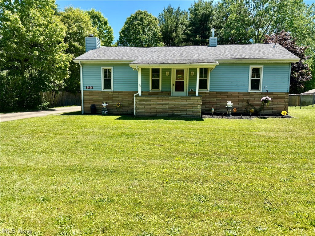 Bold, blue and ready for you; this endearing 3 bedroom, Girard ranch has all the right moves that you won’t want to miss! Set along a partially fenced-in lot with a scenic, natural backdrop, this home provides advantages in efficiency and location with its close proximity to various local attractions. Featuring a newly remodeled bathroom! The curb appeal continues as you note the two-car detached garage with additional attached shed storage. A covered rear patio provides an excellent venue for fresh air relaxation. An accompanying fence enclosure is a great perk for pet owners. Step inside to find an expansive front great room, trimmed in hardwood styled flooring and outstretched to join the kitchen with its casual dining space. Tall windows introduce plenty of natural light along the way. The robust kitchen delights with stone countertops set in tiered levels for additional dining areas. Stainless steel appliances bring a splash of bright work. Opposite the great room, a short hall ties together three inviting bedrooms and a full first floor bath. Down below, a partially finished lower family room includes a wood burning fireplace. Laundry and storage complete the floor