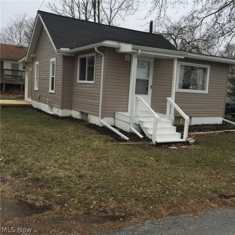 Charming three bedroom  home in the heart of Portage Lakes!   Sits on a DOUBLE LOT to have room for boats and other "toys". Huge, 720 sq ft, 2-car garage/pole building.  Oversized bright and cheery kitchen area and living rooms gives off lots of natural sunlight with it's giant windows.  Extra dry basement with additional rooms for all of your storage needs.  Easy access to boat ramps and lake.