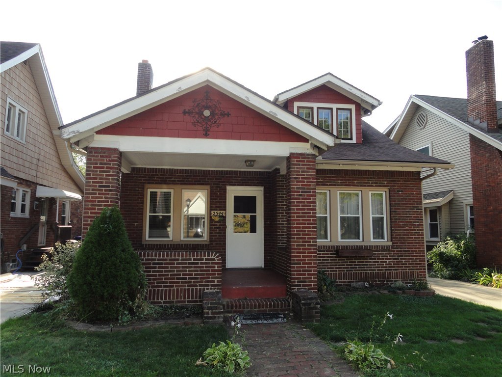 Charming brick bungalow with many desirable features.  Welcoming front porch, formal living room and dining room with laminate floors.  Built in cabinets & wood burning fireplace.  Cute kitchen with Corian counters & updated floor.  Updated bathroom beautifully done.  Two bedrooms on first floor and huge bedroom on 3rd floor with 3 closets and a decorative fireplace.  Hardwood floors in all bedrooms.  Newer windows on 1st floor and new roof in 2005.  Concrete driveway, fire pit, partially fenced semi private backyard.