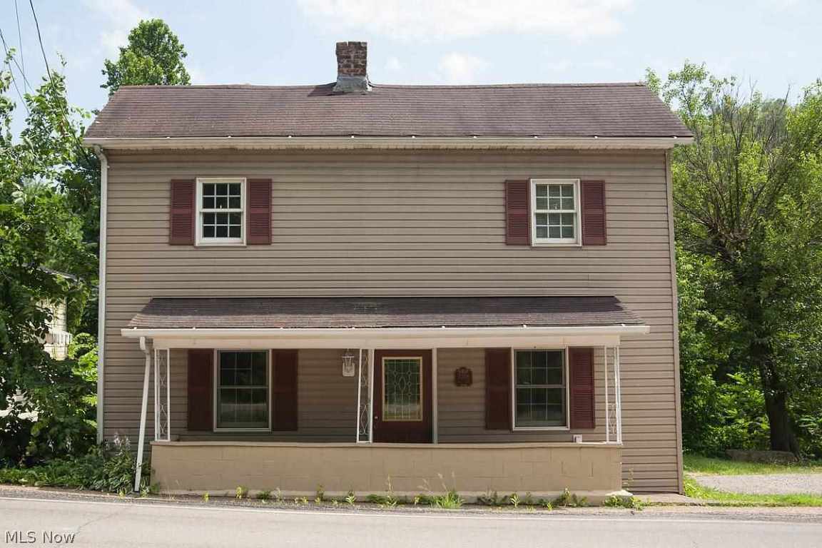 Home has beautiful large living room and large kitchen and dining area, all hardwood floors. Three bedrooms with full bath upstairs. Large two story covered deck with a relaxing view of the stream running behind the house. Half bath toilet only under the steps in living room.