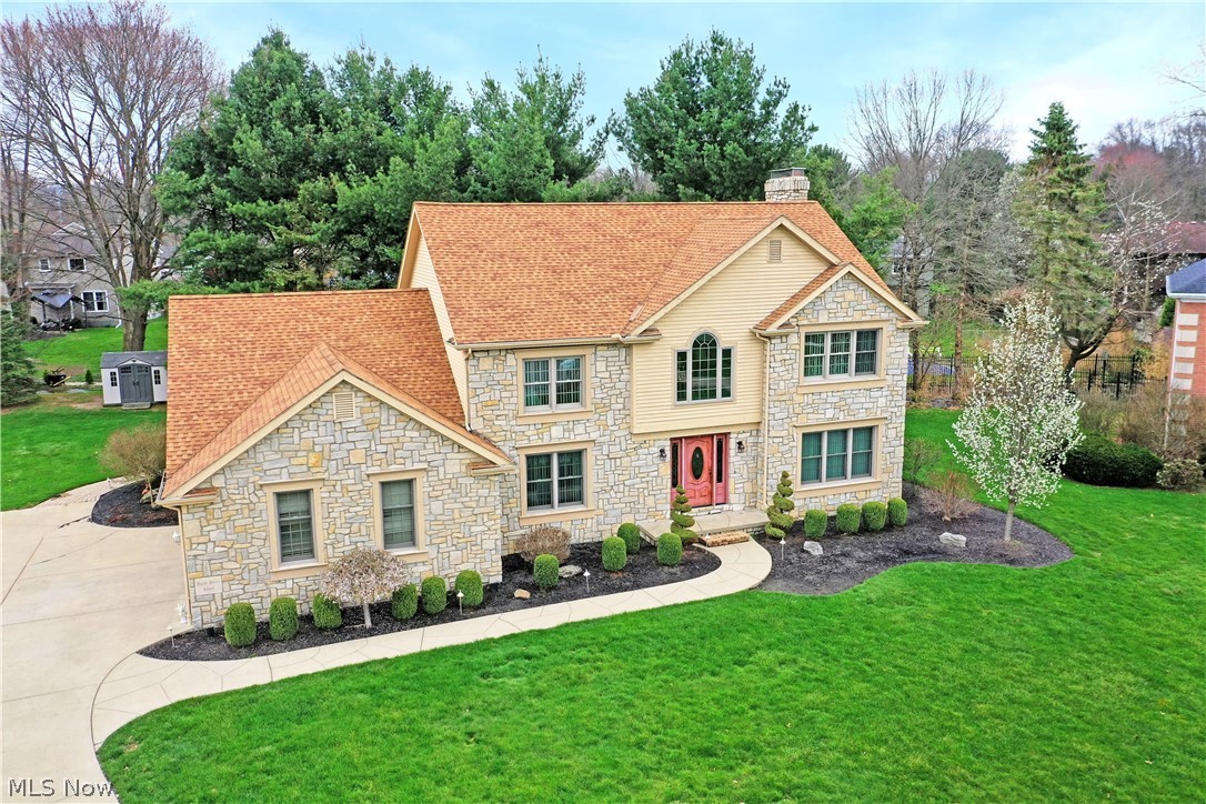 You’ve been patiently waiting and now we’re here to deliver! Homes like this don’t pop up often, so don’t hesitate. Welcome to the stunning surroundings of this expansive, four-bedroom Howland estate, tucked away in a quiet cul-de-sac, within a highly desirable neighborhood of custom build homes. An instant standout, lavish stonework creates an engaging façade as arch topped windows rise above the two-story foyer. The cement driveway snakes around to find a two-car attached garage while the tall trees create natural privacy for the rear deck and patio areas. Step inside as lovely hard wood flooring draws you near, spilling into the nearby formal dining room, must-see kitchen and great rooms. Soft, cream carpeted stairs rise away to the second-floor bedrooms as a relaxing family room shares the treatment, boasting its three oversized windows. A stepped ceiling enriches the dining room, but the real showpiece is the amazing, open layout kitchen and its own sky light adorned dining area. Arch topped windows line the far well, adding to the allure while the polished stone counters glisten nearby. The adjacent living room enjoys its stone mantle with fireplace, doubling down with deck access. Opposite the kitchen, a full bath, first floor laundry, and a large office are located near the garage entrance. Upstairs, be swept away by the elaborate master suite, containing a pair of walk-in closets and a stunning full private bath with bespoke tiling, tub and dual vanities. An additional full bath awaits mid hall as the trio of guest bedrooms increases in size. Down below a full basement provides plenty of storage plus a bonus room for rec space.