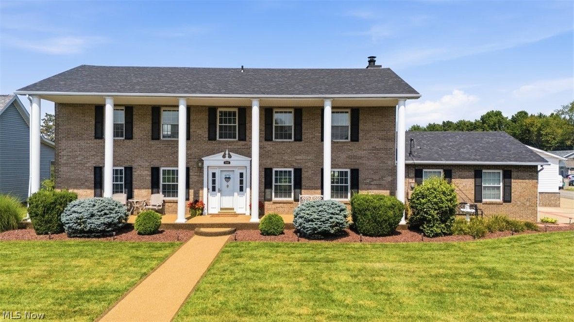 Perfectly positioned on an oversized corner lot in one of Mineral Wells most sought-after neighborhoods, this beautiful brick Colonial offers the kind of setting buyers dream about but rarely find. Overlooking the golf course with stunning water views and unforgettable sunsets, every day here feels elevated. From the moment you arrive, the stately columns, sprawling front porch, and manicured landscaping create a first impression that's impossible to forget. Step inside and you'll discover a home that has been lovingly maintained. Beautifully renovated with both style and function in mind, the kitchen offers an inviting eat-in dining space framed by spectacular golf course views. The formal dining room provides a picturesque backdrop of the lake and rolling greens.  Upstairs, four generously sized bedrooms await, including a spacious primary suite, while the convenient main-level laundry room makes everyday a little easier. The outdoor living spaces are every bit as impressive. You'll find yourself spending countless hours in the three-season room, morning coffee on the expansive front porch, cookouts on the rear deck, and you'll fall in love with the white picket fenced backyard that feels like something straight out of a storybook. Need space for projects or all your toys? In addition to the attached two-car garage and extra parking pad, you'll love the fabulous 40 x 24 heated detached garage. Homes that combine timeless elegance, exceptional maintenance, premium golf course views, and an oversized lot in this desirable Mineral Wells location are a rarity. I suggest you hurry. This listing is going to move fast!