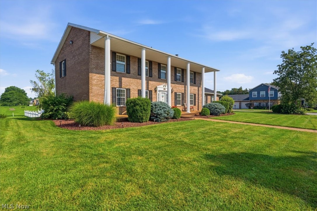 Perfectly positioned on an oversized corner lot in one of Mineral Wells most sought-after neighborhoods, this beautiful brick Colonial offers the kind of setting buyers dream about but rarely find. Overlooking the golf course with stunning water views and unforgettable sunsets, every day here feels elevated. From the moment you arrive, the stately columns, sprawling front porch, and manicured landscaping create a first impression that's impossible to forget. Step inside and you'll discover a home that has been lovingly maintained. Beautifully renovated with both style and function in mind, the kitchen offers an inviting eat-in dining space framed by spectacular golf course views. The formal dining room provides a picturesque backdrop of the lake and rolling greens.  Upstairs, four generously sized bedrooms await, including a spacious primary suite, while the convenient main-level laundry room makes everyday a little easier. The outdoor living spaces are every bit as impressive. You'll find yourself spending countless hours in the three-season room, morning coffee on the expansive front porch, cookouts on the rear deck, and you'll fall in love with the white picket fenced backyard that feels like something straight out of a storybook. Need space for projects or all your toys? In addition to the attached two-car garage and extra parking pad, you'll love the fabulous 40 x 24 heated detached garage. Homes that combine timeless elegance, exceptional maintenance, premium golf course views, and an oversized lot in this desirable Mineral Wells location are a rarity. I suggest you hurry. This listing is going to move fast!
