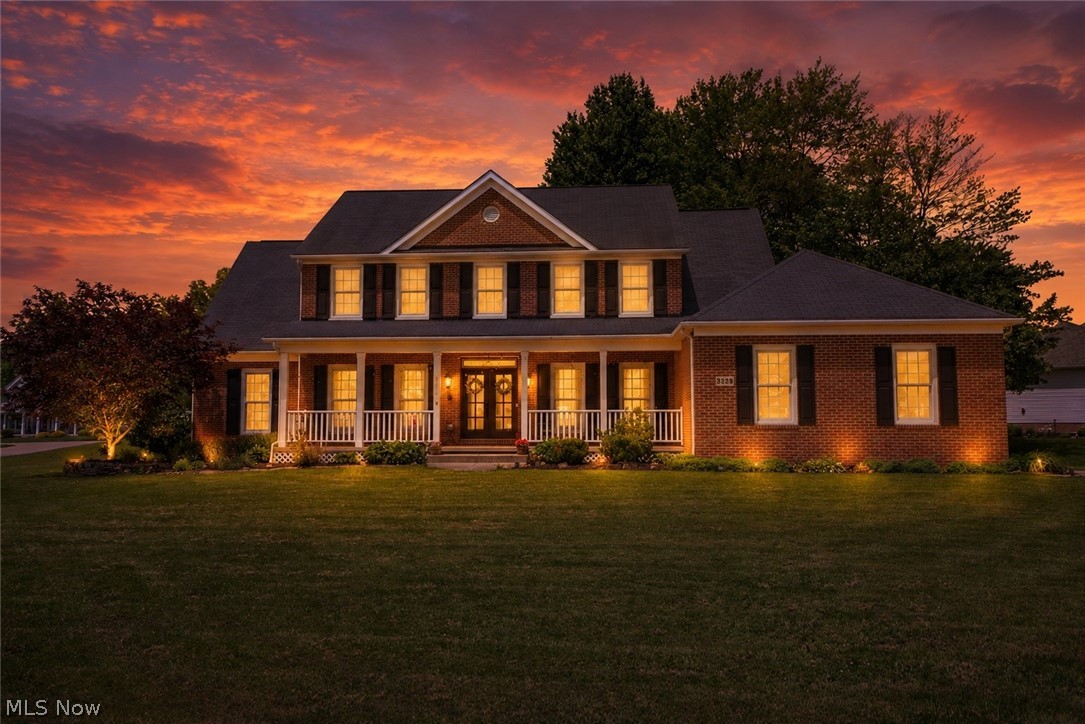 Set on a beautiful corner lot in Mystic Pointe, this all-brick Colonial makes a memorable impression with its timeless curb appeal, covered front porch, and charming gas lanterns. Inside, the two-story foyer opens to a home that feels both elegant and inviting, with thoughtful updates, engineered hardwood flooring, and spaces designed for gathering, relaxing, and everyday comfort.

At the heart of the home is a truly stunning kitchen that brings together style, function, and a high-end feel. Skylights fill the space with natural light, while quartz countertops, a tile backsplash, pantry, breakfast bar, and updated appliances create a polished setting for cooking and entertaining. The generous layout flows beautifully into the breakfast nook, where walls of windows overlook the backyard and lead seamlessly outdoors.
The dramatic two-story great room, where a floor-to-ceiling stone fireplace creates a striking focal point and warm gathering space. A formal dining room adds an elevated space for hosting, while the front living room and private office with built-in bookcases offer flexibility for work or quiet retreat. A vaulted sunroom extends the living space with a peaceful place to unwind.
The main level also includes a laundry room and a first-floor bedroom with nearby full bath, ideal for guests or in-law suite potential. 

Upstairs, the open landing overlooks the foyer and great room, leading to a spacious primary suite with walk-in closet and private bath featuring dual sinks, soaking tub, separate shower, and private commode area. Two additional bedrooms and an updated full bath complete the second floor.

With a full unfinished basement, heated 2.5-car garage, inviting patio space, and a wonderful neighborhood setting, this beautifully updated Mystic Pointe home offers comfort, character, and an elevated everyday lifestyle.
