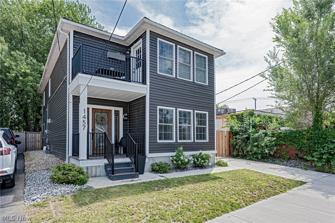 Enjoy city life at its best in this spectacular colonial in the heart of Ohio City! Originally built in 1900, this home was completely transformed in 2020 with modern smart features and on-trend, high quality finishes throughout. Plus, it is tax abated until 2035! Wide plank hardwood floors greet you in the foyer and flow into the open kitchen and living area. With quartz counters, a waterfall island, a farmhouse sink, and a custom bar area, the kitchen will take your breath away. Smart appliances make living a breeze, including a hands free sink, a ZLine 36” professional range and hood, a Samsung smart fridge, dishwasher, and microwave. The kitchen overlooks the great room, which features a coffered fireplace and large windows to welcome natural light. Sliding doors open out to the back deck, and the backyard is fully fenced-in with a low-maintenance turf lawn, perfect for pets. One bedroom and one full bathroom are on the first floor, perfect for a home office or guest suite. Upstair