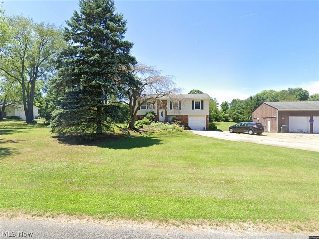 Cozy country bi-level home situated on 2.33 acres in the Southeast Local School District, offering a peaceful setting with a scenic rolling lot and creek. The property includes a spacious 30x40 pole building featuring a third bay with an extra tall door, RV hookup, and space perfect for RV parking, storage, equipment, hobbies, or workshop use. Major updates include a roof installed in 2012, windows approximately 10 years old, and kitchen cabinets updated within the last 15 years. The home is being sold as is and offers an excellent opportunity for buyers looking to add their own finishing touches. Enjoy the privacy of a country setting while still being conveniently located near local amenities. A beautiful lot, versatile outbuilding, and strong potential make this property a must see. Contact listing agent Charles Burmeister at 216-804-7308 with questions or showing requests.