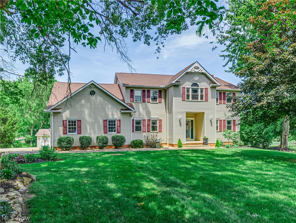 Welcome to this stunning Colonial in Cuyahoga Falls, offering 4 bedrooms, 3.5 bathrooms, and 3,495 sq. ft. of above-grade living space, plus an additional 1,300 sq. ft. in the fully finished walk-out lower level. Situated on 2.09 acres, this well-maintained and thoughtfully designed home is ideal for both everyday living and entertaining. The main level features a formal dining room with tray ceiling and classic oak chair rail. Across the foyer, the den/formal living room offers crown molding and French doors opening into the spacious family room. Filled w/natural light and centered by a beautiful brick fireplace, the family room flows seamlessly into the large eat-in kitchen with generous dining area, center island, stainless steel appliances, granite counters, and abundant cabinetry. Sliding glass doors off the kitchen lead to the deck overlooking the backyard, above-ground pool, and wooded backdrop for a private, peaceful setting. A half bath, laundry room, and access to the oversized attached 2-car garage (an additional 3-car detached garage) complete the main level. Upstairs, the spacious primary suite features vaulted ceilings, a sitting area, and an en suite bath with dual vanities, soaking tub, walk-in shower, and his & hers walk-in closets. Three additional bedrooms and a full bath complete the second level. The finished walk-out LL adds 1,300 sq. ft. with a large rec room, kitchenette, full bath, and ample storage/utility space. Walk-out access leads to the patio, pool, and backyard, making it ideal for entertaining or multi-generational living. Additional features include an oversized 3-car detached garage, bringing the total garage capacity to 5 vehicles, 6-panel doors throughout, along with a roof that is approximately 5 years old. Conveniently located near Portage Crossing, Cuyahoga Valley National Park, Blossom Music Center, and nearby dining and entertainment options. Don’t miss the opportunity to make this beautiful home and property yours today!