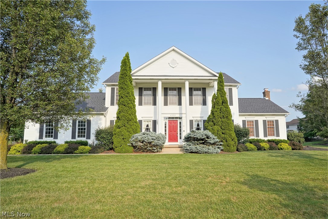 Gorgeous Georgian style colonial located in highly sought after Eastwicke Farms! Close to Metro Bike/Hike Trail, Silver Springs Park, Fox Den Golf Course and much more! Beautiful front porch graced with stately pillars highlights the front elevation of this home. Upon entering this home, you will see a pride of ownership the current owners have given to this home. Spacious foyer with ceramic flooring leads you to both the formal living room and dining room with hardwood flooring. Beautiful hardwood flooring. Straight to the rear of the home is the oversized kitchen with dinette area flanked with hardwood flooring. The bayed kitchen has granite countertops and tile backsplash. There is also a built-in desk. There are patio doors leading to the rear patio, great for relaxing outdoors. The vaulted family room boasts a floor to ceiling brick fireplace that is wood burning with a gas starter. For your convenience there is first floor laundry room.  The second floor is home to 4 bedrooms one
