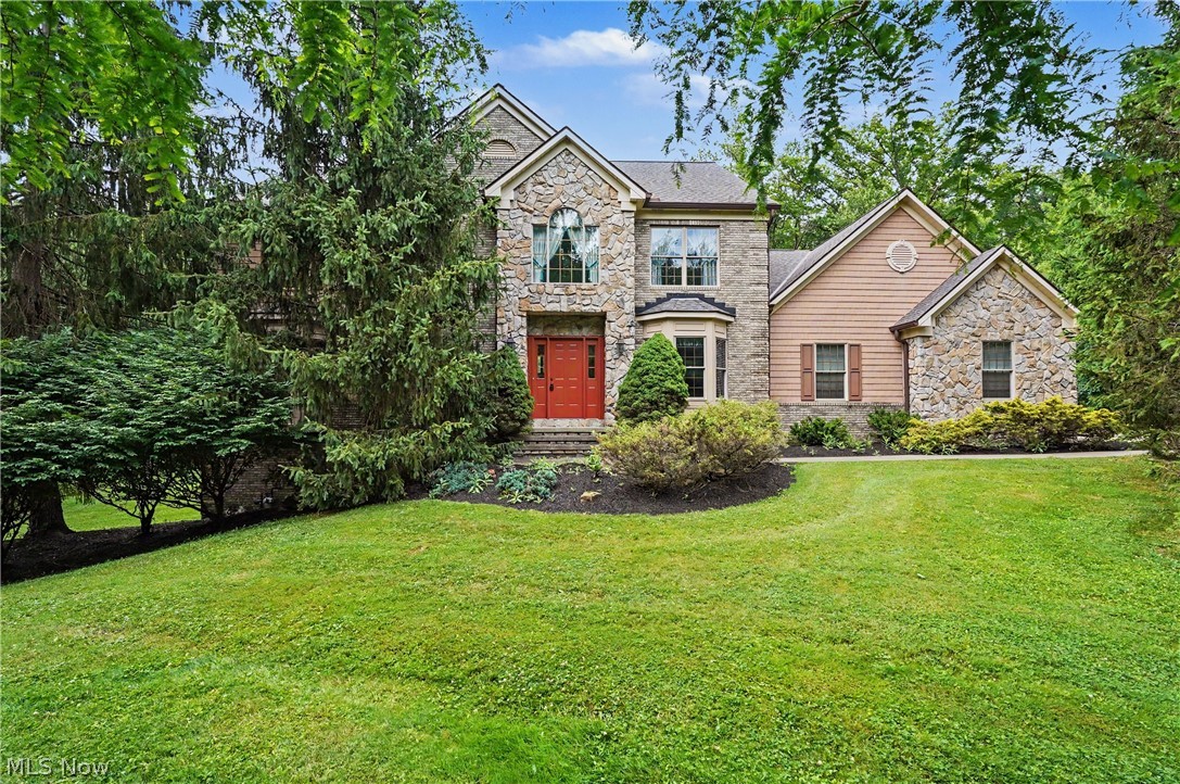 OFFERRED FOR THE FIRST TIME since being custom built in 1998 by renowned RL Design Builders.  In the sought-after Rory Glen subdivision, this CUSTOM BRICK COLONIAL sits back on 3 private acres and rewards every buyer who steps through the door. A gracious ceramic tile foyer opens directly into the great room, where a soaring vaulted knotty pine ceiling, two-story stone gas fireplace, and a wall of glass doors with windows above flood the space with light and warmth. To the right, an oversized octagonal formal dining room with tray ceiling is made for entertaining. The custom kitchen features an island, eat-in bay window, custom oak cabinetry, Wilsonart solid surface counters, and brand new stove and refrigerator. From the great room, a DRAMATIC 48-INCH OPEN TREAD STAIRCASE rises to an open balcony overhead, a signature moment that carries the custom oak woodwork found in every room of this home. The main floor also offers a private office with built-in oak bookcase, a theatre room with beamed ceiling, and an entertainment bar with sink. Upstairs, the primary suite features dual walk-in closets, dual sinks, a soaking tub, an elegant shower, and a private deck. Nearly 4,700 total finished sq ft includes 3 gracious bedrooms (plus Theatre room can be a main floor bedroom) and 4 ½ baths, A full finished walkout basement with dedicated workout area and full bath built with 14-course commercial-grade block walls. The heated 3-car garage with built-in air compressor, mud room/workshop on first floor, backup generator + transfer switch, security system, Kinetico water softener w/ R/O system and driveway alert all convey. 2021 roof and 2021 A/C. 1-year home warranty. Chardon Local Schools (ranked 90/100). Schedule your private viewing today.