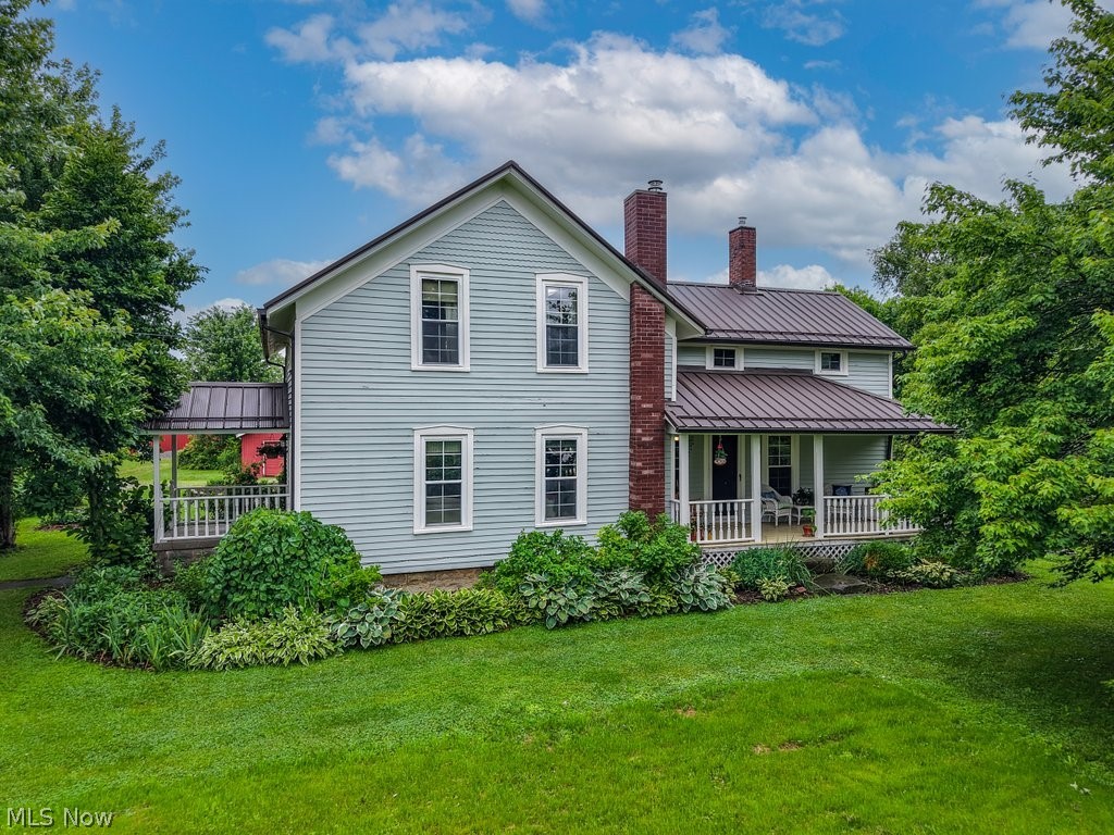 A storybook equestrian homestead like this doesn't come around often! This welcoming farmhouse, full of character, offers 4 bedrooms, 2 full bathrooms, and nearly 1,900 square feet of finished living space. You'll be greeted by three inviting porches-front, side, and rear. Throughout the first floor, you'll find absolutely beautiful antique hardwood floors that were refinished in 2021. The kitchen was completely renovated in 2021 and features Café appliances, leathered granite countertops, and custom-built cabinetry. The first floor is completed by a formal dining room, spacious living room with a wood-burning stove, laundry room, and full bathroom. Upstairs, you'll find four bedrooms and an additional full bathroom. Major updates include a new metal roof (2019), furnace (2018), hot water tank (2024), and paver patio (2022). Situated on 8 picturesque acres, the property features an established organic garden, mature perennials, fruit trees,  native plantings, and pond. Keep your horses going year-round with over 10,000 square feet of barn and arena space. The barn offers 9 stalls of varying sizes, a viewing room, hay loft, feed room/tack room. The indoor arena (130' x 60') with Race Track footing and jumping ceiling clearance was added in 2015, while the outdoor limestone arena (100' x 150') was added in 2018. The established, well-maintained pastures are fenced with high-tensile smooth wire fencing, making this farm ready to enjoy from day one. Conveniently located just 19 minutes from Cleveland Hopkins Airport, 25 minutes from downtown Cleveland, and only minutes south of Lorain Road near I-480 and the Ohio Turnpike. Whether you're a competitor, recreational rider, or simply someone who dreams of having horses at home, this property delivers. Offering the perfect balance of horse facilities, usable acreage, and a charming residence, this is a place where countless memories can be made both in and out of the saddle.