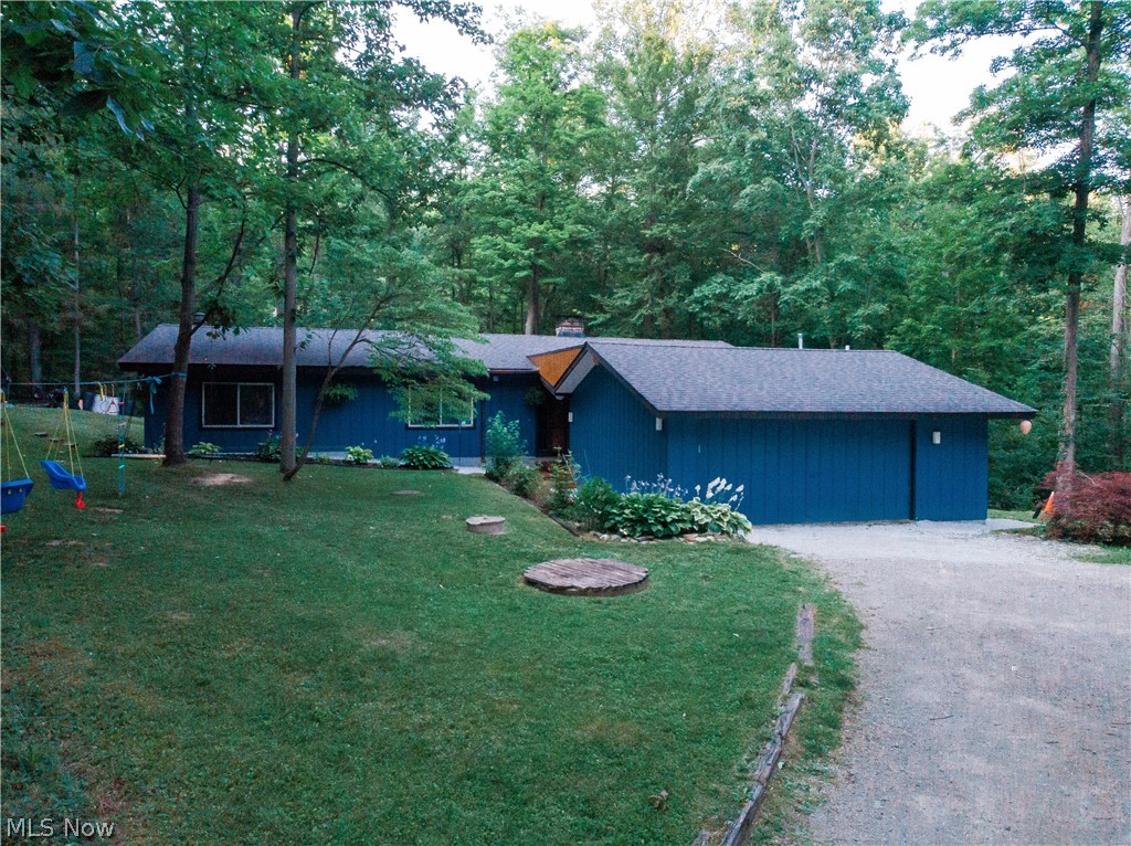Discover the perfect blend of privacy, comfort, and natural beauty in this spacious 4-bedroom, 2-bath ranch nestled on a secluded 1.79-acre lot in the highly sought-after Bass Lake Community of Chardon/Munson Township.

Step inside to an inviting open-concept great room featuring soaring natural wood vaulted ceilings, beautiful hardwood floors, abundant natural light, and a cozy fireplace. Designed with both comfort and functionality in mind, the great room easily accommodates both living and dining spaces. The eat-in kitchen offers ample cabinet and counter space.

Each of the four generously sized bedrooms features vaulted ceilings, enhancing the home's spacious feel. The private primary suite provides a peaceful retreat with its own full bath, charming wood-burning stove, and loft area. Sliding glass doors from both the primary bedroom and a second bedroom provide convenient access to the backyard and invite the outdoors in.

Outside, you'll appreciate the peaceful setting as the gently sloping yard leads to a scenic creek and wooded ravine, creating a picturesque backdrop throughout the seasons. With nearly 1.8 acres, there's plenty of room for outdoor entertaining, gardening, recreation, or simply enjoying nature. A chicken coop offers the opportunity for a hobby farm lifestyle, while a spacious outbuilding provides excellent storage, workshop space, or room for your favorite projects.  The attached two car garage has its own heater.

Located just down the street from beautiful Bass Lake, the community clubhouse, and park grounds, this home offers optional club membership and access to the many recreational amenities that make this neighborhood such a special place to call home.