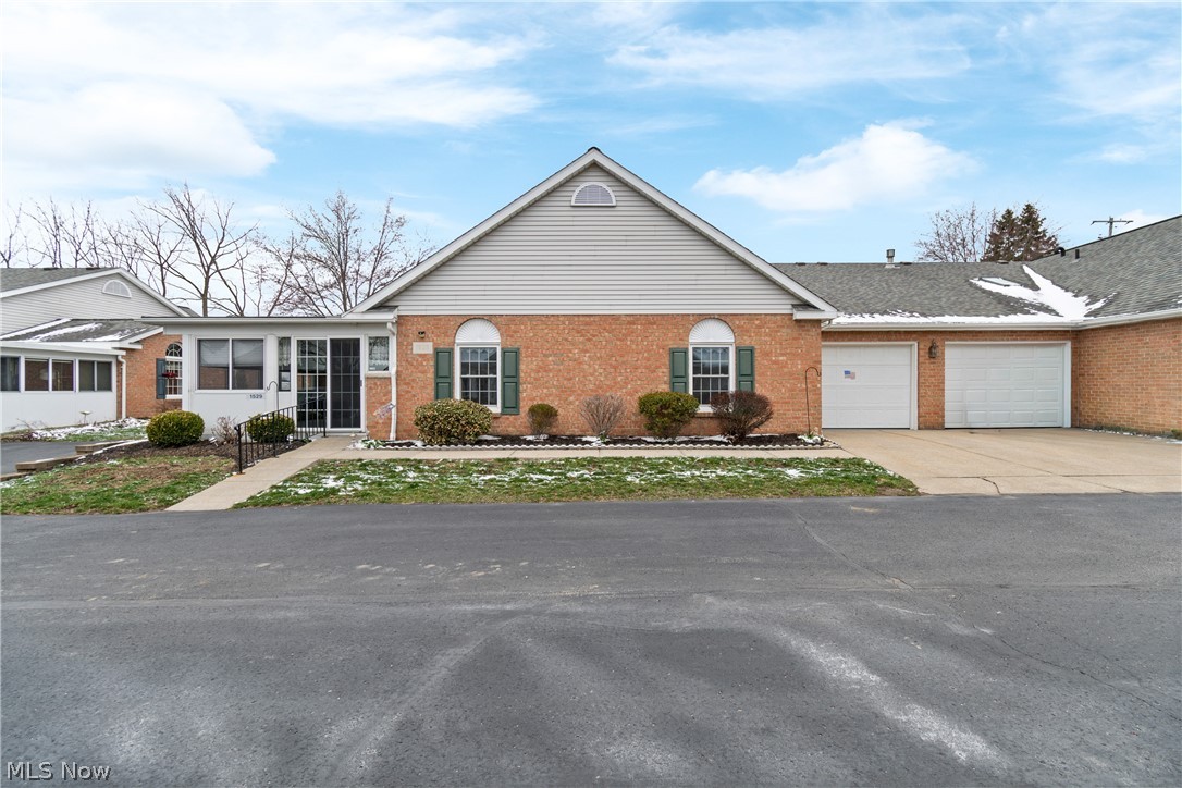 Experience the perfect blend of comfort and convenience in this beautiful, brick ranch condo located in the highly sought-after Hartville Country Commons 55+ community. Designed specifically for those looking to avoid stairs, this one-level home offers a seamless floor plan and modern updates throughout.The heart of the home is the open-concept kitchen and family room, featuring soaring vaulted ceilings that create a bright, airy feel. The kitchen has been thoughtfully refreshed with brand-new vinyl plank flooring, a new dishwasher, a stainless steel sink, and a new garbage disposal. The spacious primary bedroom offers direct access to the full bathroom, while a second half-bath—updated with a new toilet—provides the perfect setup for guests. What truly sets this unit apart is the rare enclosed seasonal room, offering a peaceful retreat to enjoy the outdoors for most of the year. Additional highlights include main-level laundry, an attached one-car garage, and extra guest parking. Located just moments away from shopping and the iconic Hartville Kitchen, this move-in-ready home makes downsizing a dream.